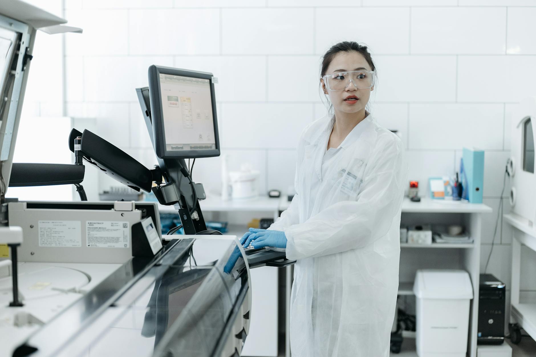 female medical practitioner standing in front of a monitor