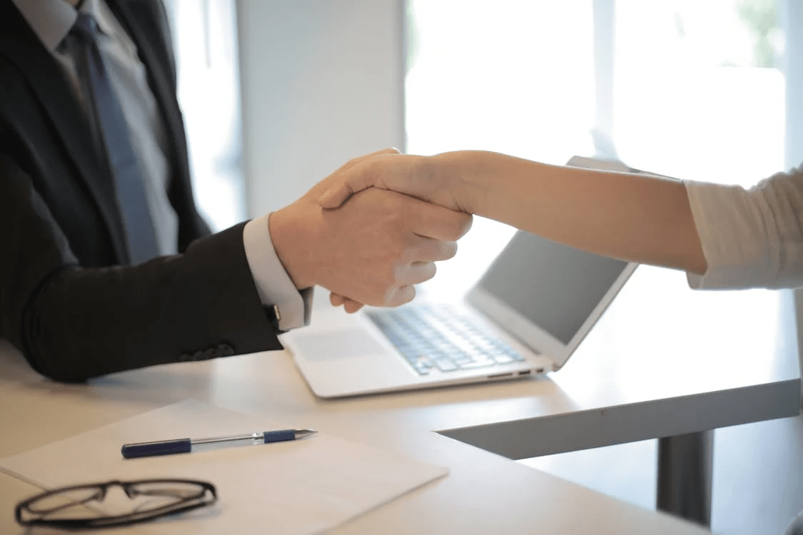 Handshake following effective cover letter salutation and successful interview
