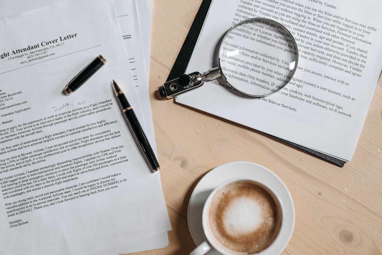 over letters and resumes kept on a desk with coffee