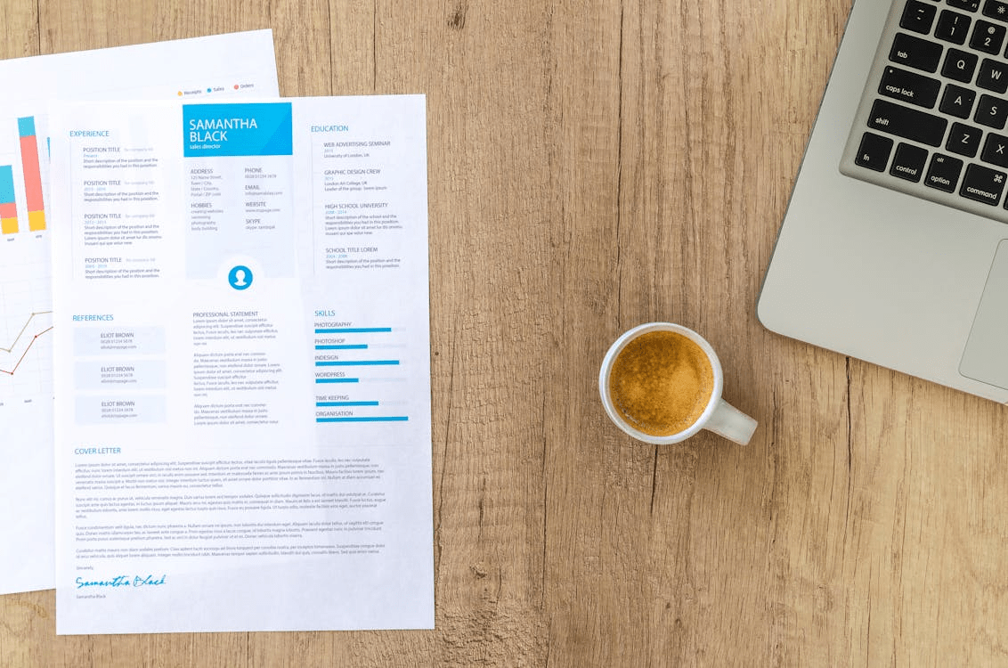 Resume and coffee cup on wooden desk
