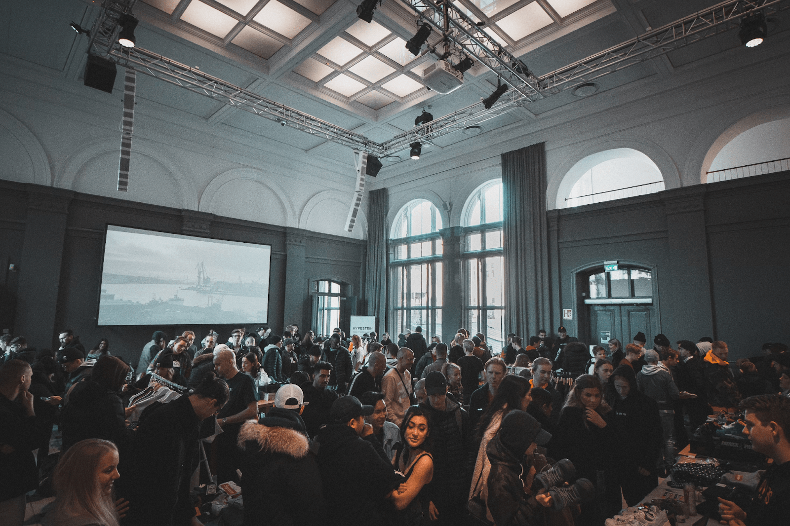 A professional networking event with attendees engaging in conversations, showcasing the benefits of networking.