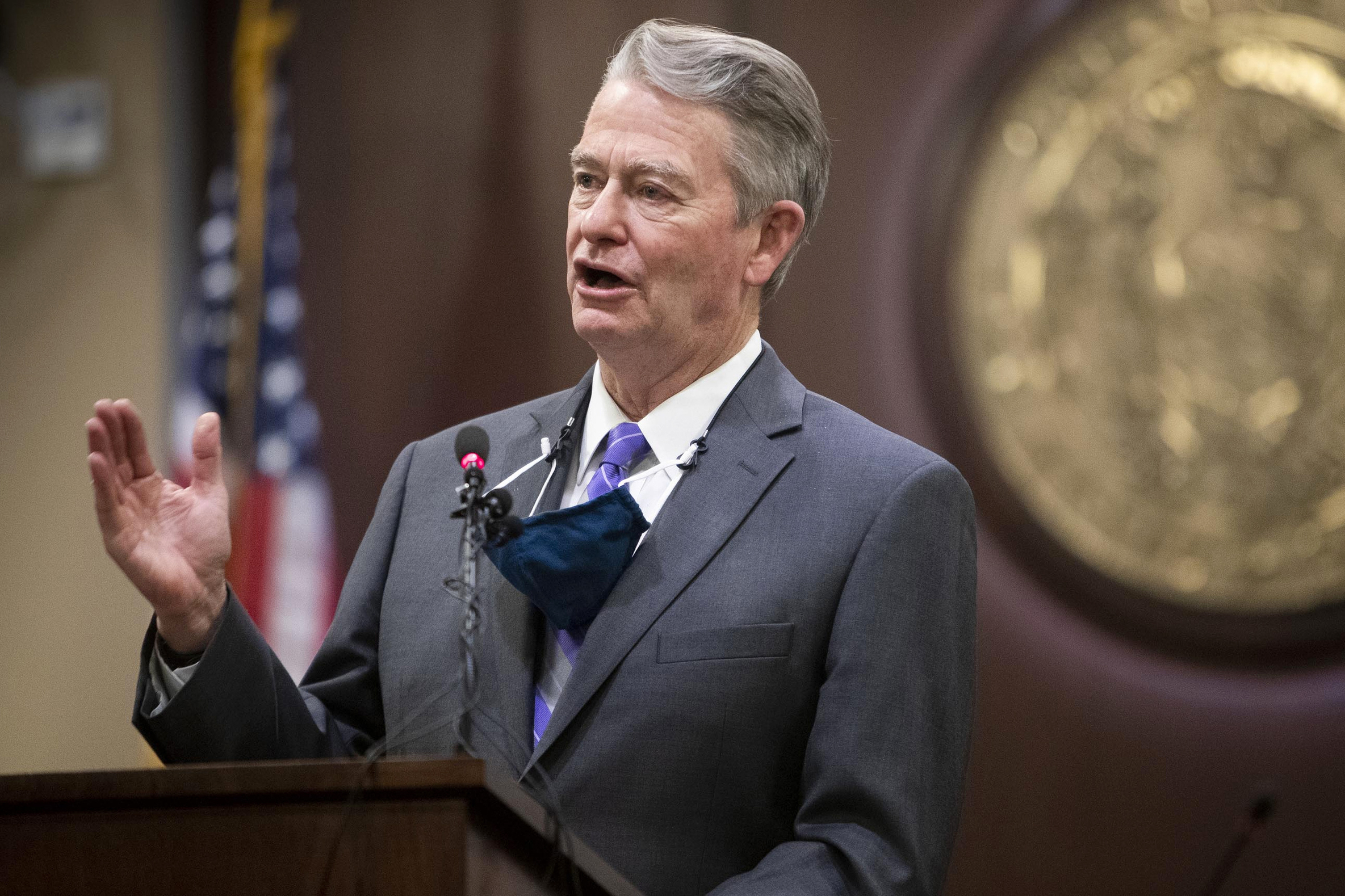 Idaho Gov. Brad Little gestures during a press conference.