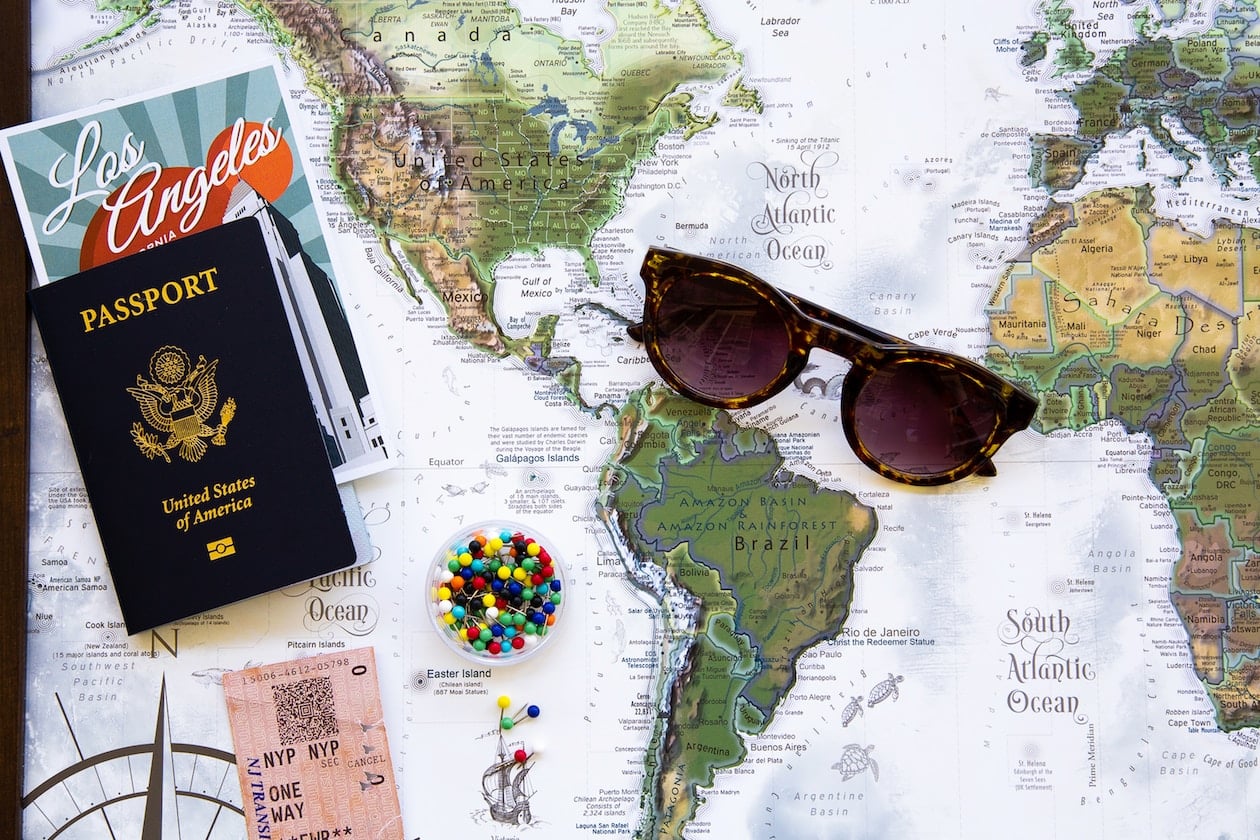 brown framed sunglasses on map-preparing for international travel