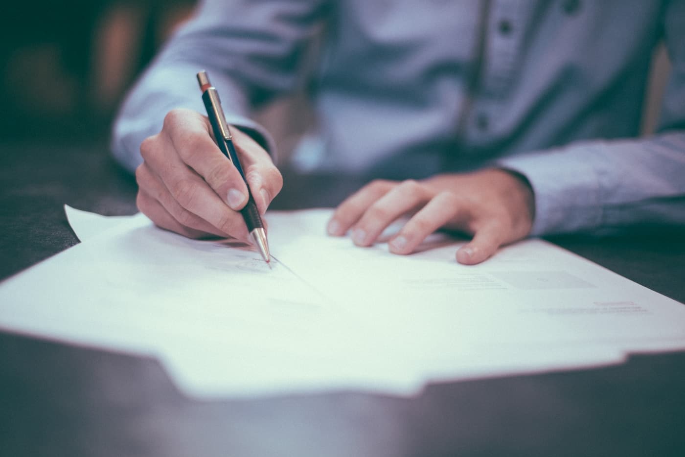 man writing on paper-Travel Insurance Jargon