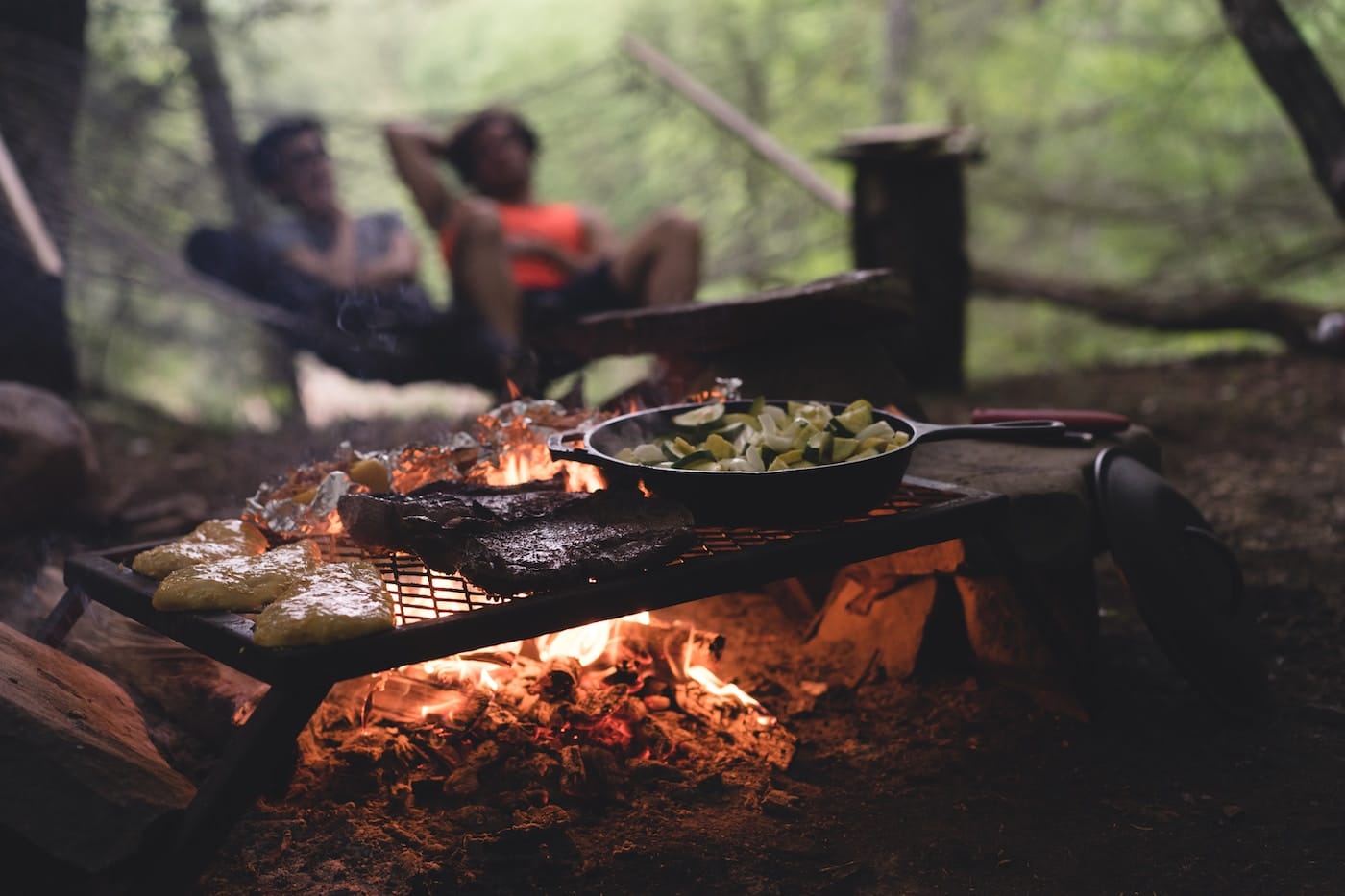 selective focus photo of skillet and meat on top of grill with fire-What to Cook Over a Campfire