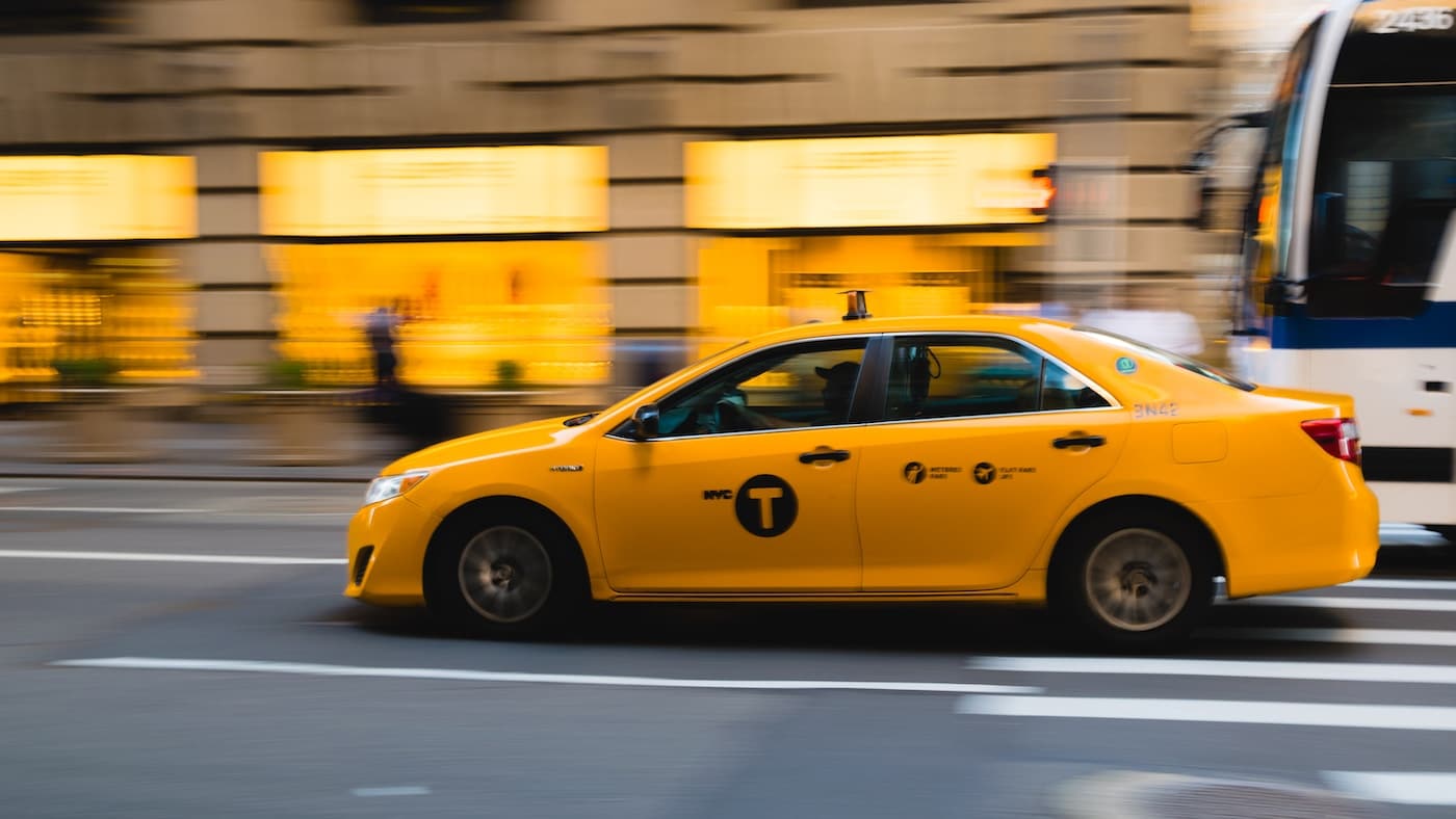 tilt shift photography of yellow taxi car-Taxi Tips