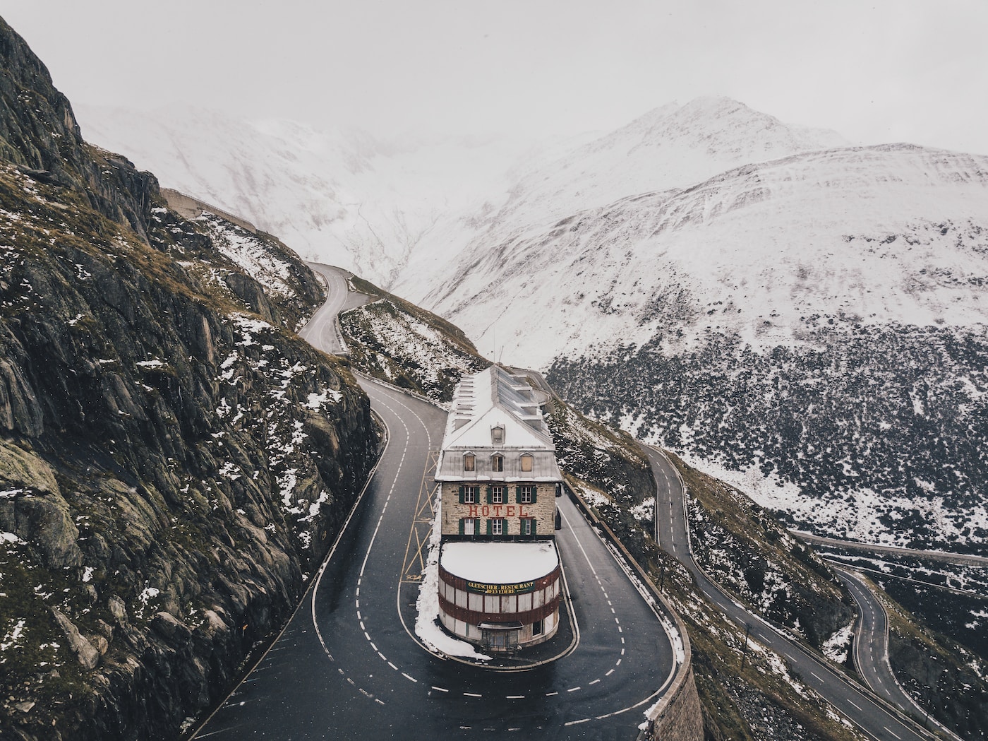 aerial view photo of concrete building near road in zig zag road-Switzerland Solo Travel