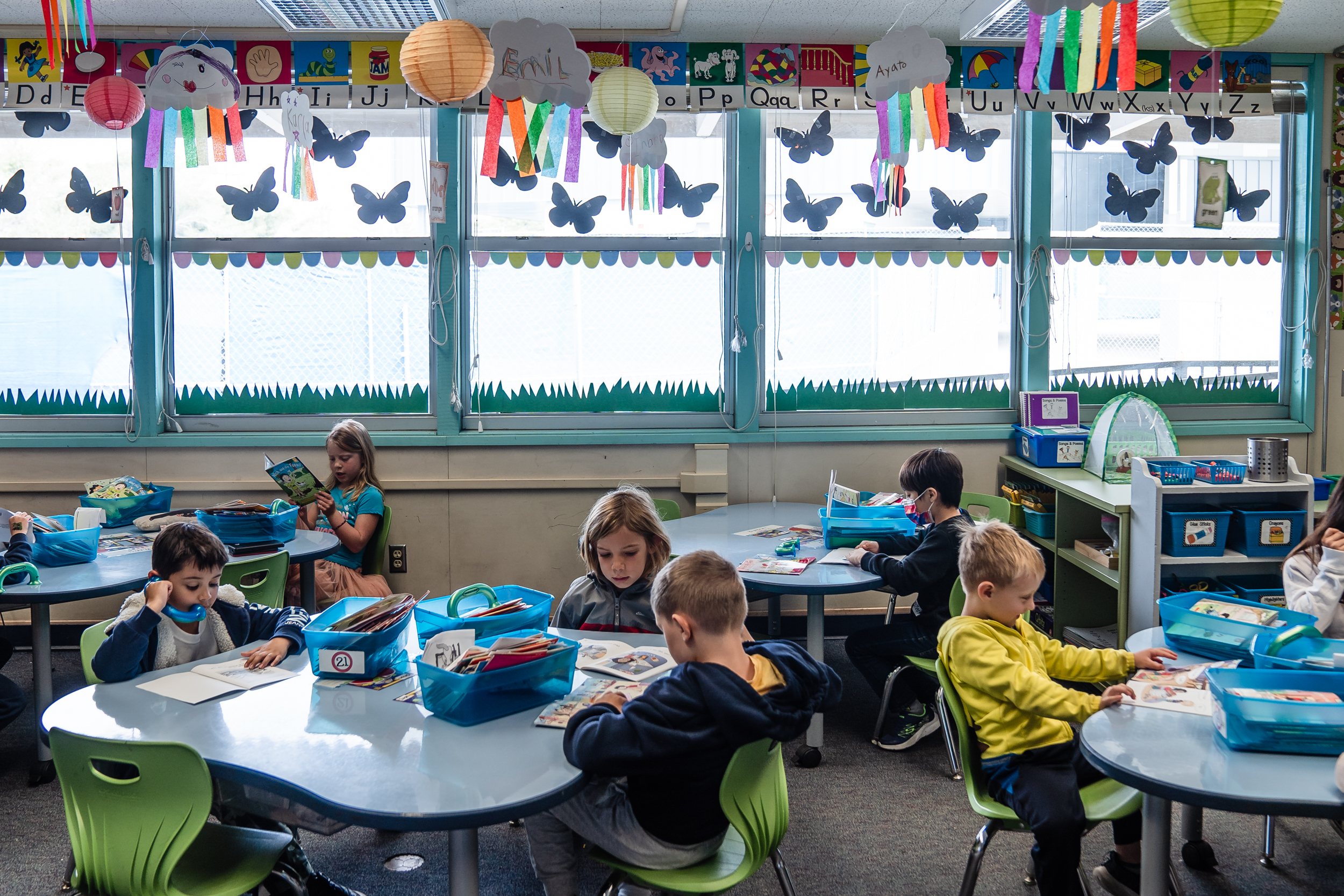 Kindergarten students listen to themselves read during a class assignment at Spreckels Elementary school in University City on April 24, 2023.