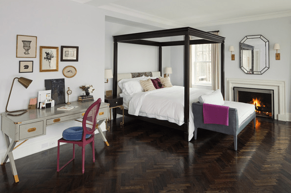 bedrooms - gray campaign sawhorse desk gold hardware pink cane chair royal blue round tufted cushion black canopy bed gray velvet bench octagon mirror fireplace glossy wood floors chevron herringbone pattern