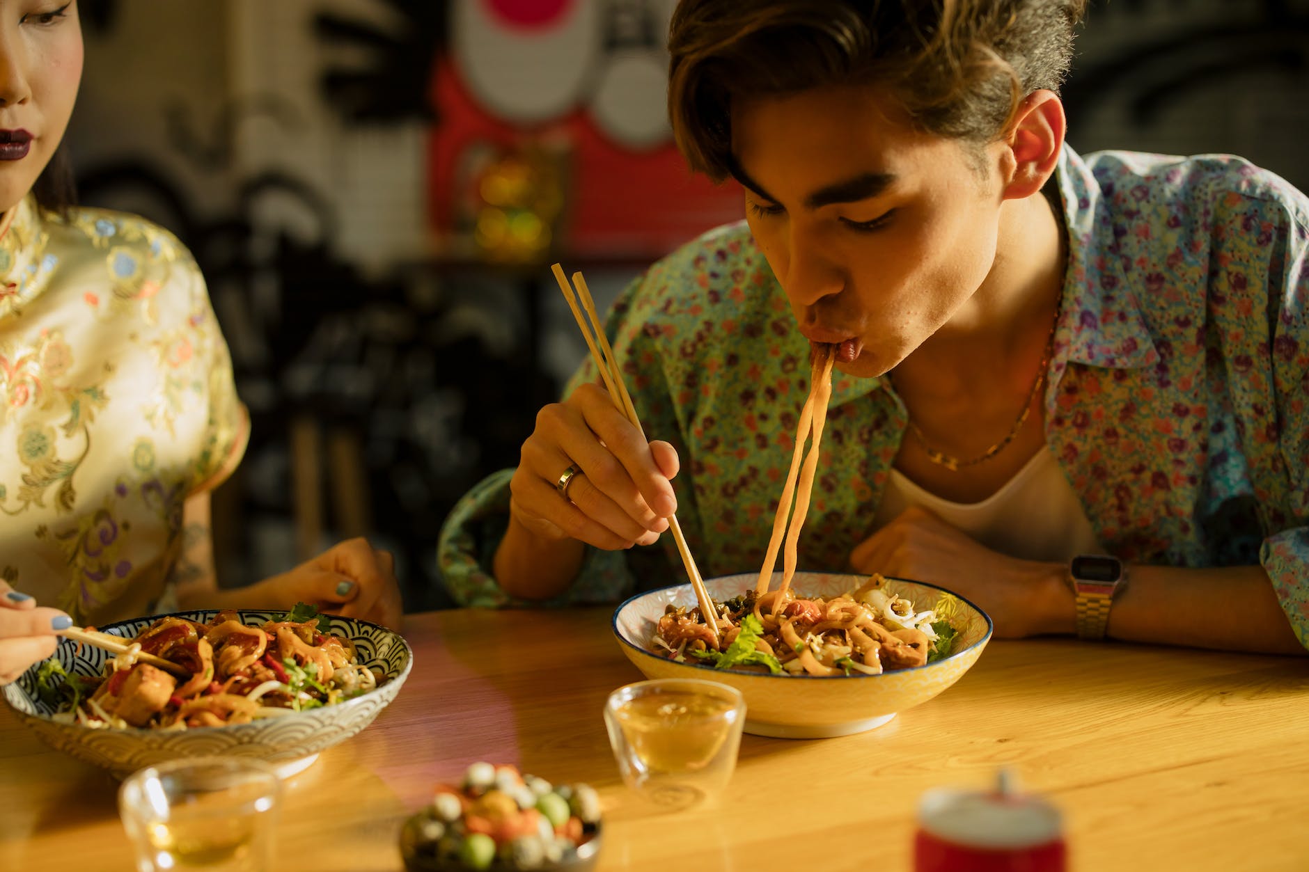 man eating noodles