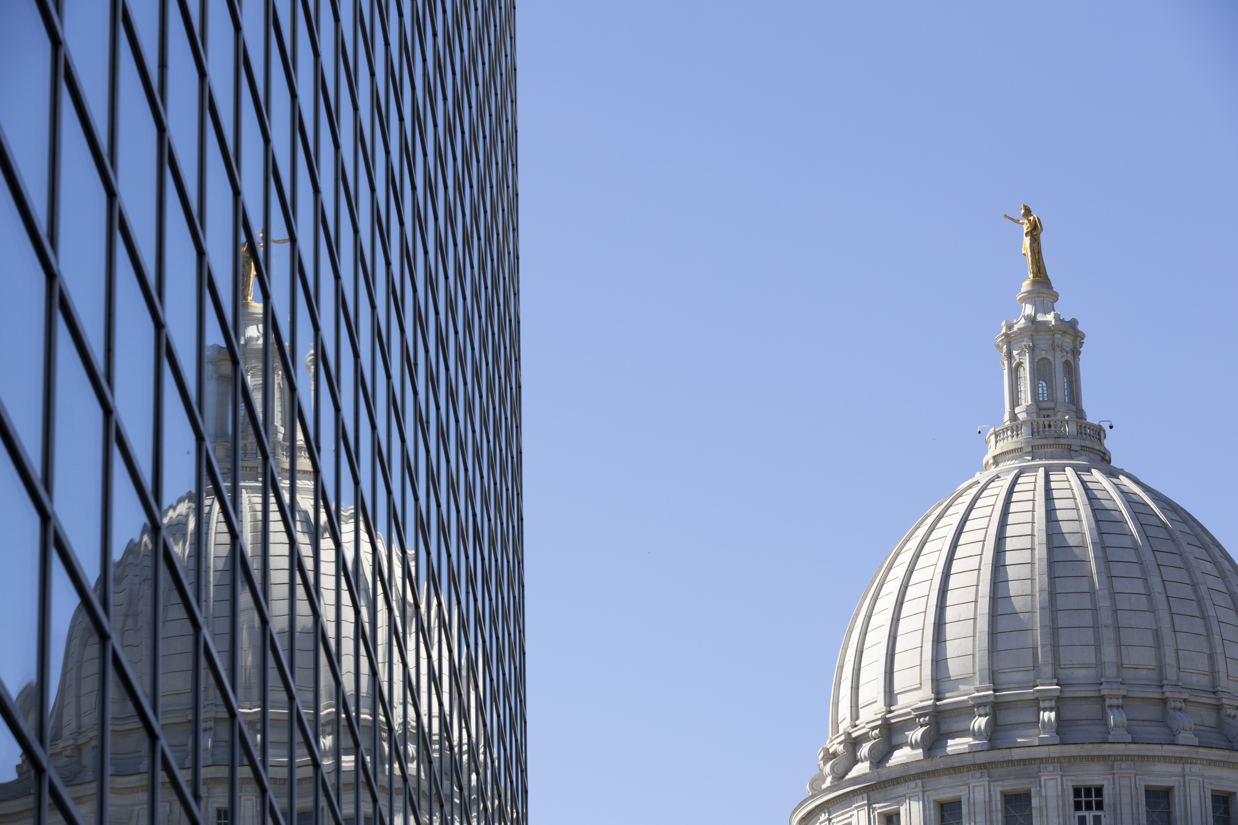 The Wisconsin State Capitol dome is reflected on windows.
