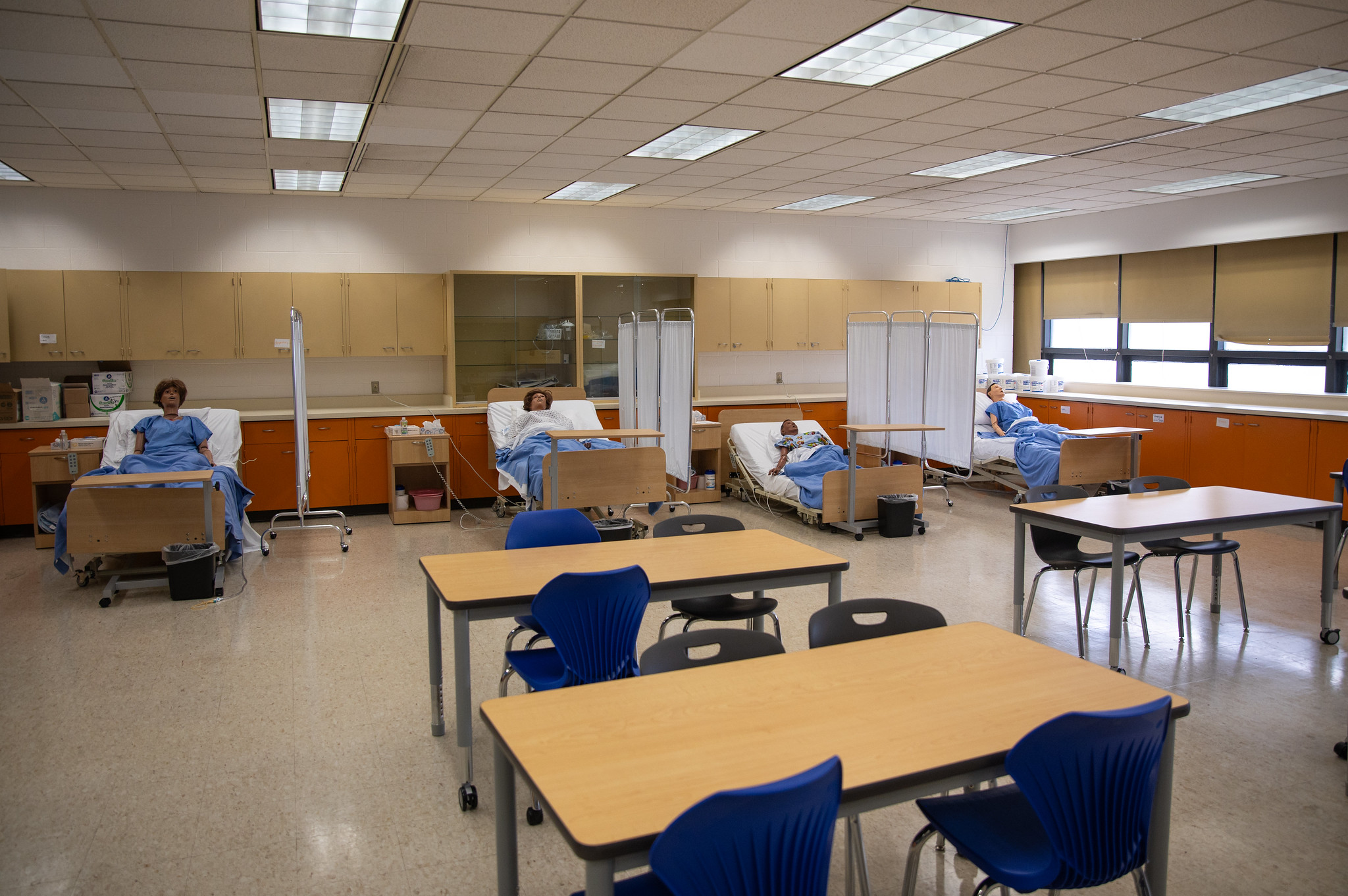 Classroom with desks and dummies in beds