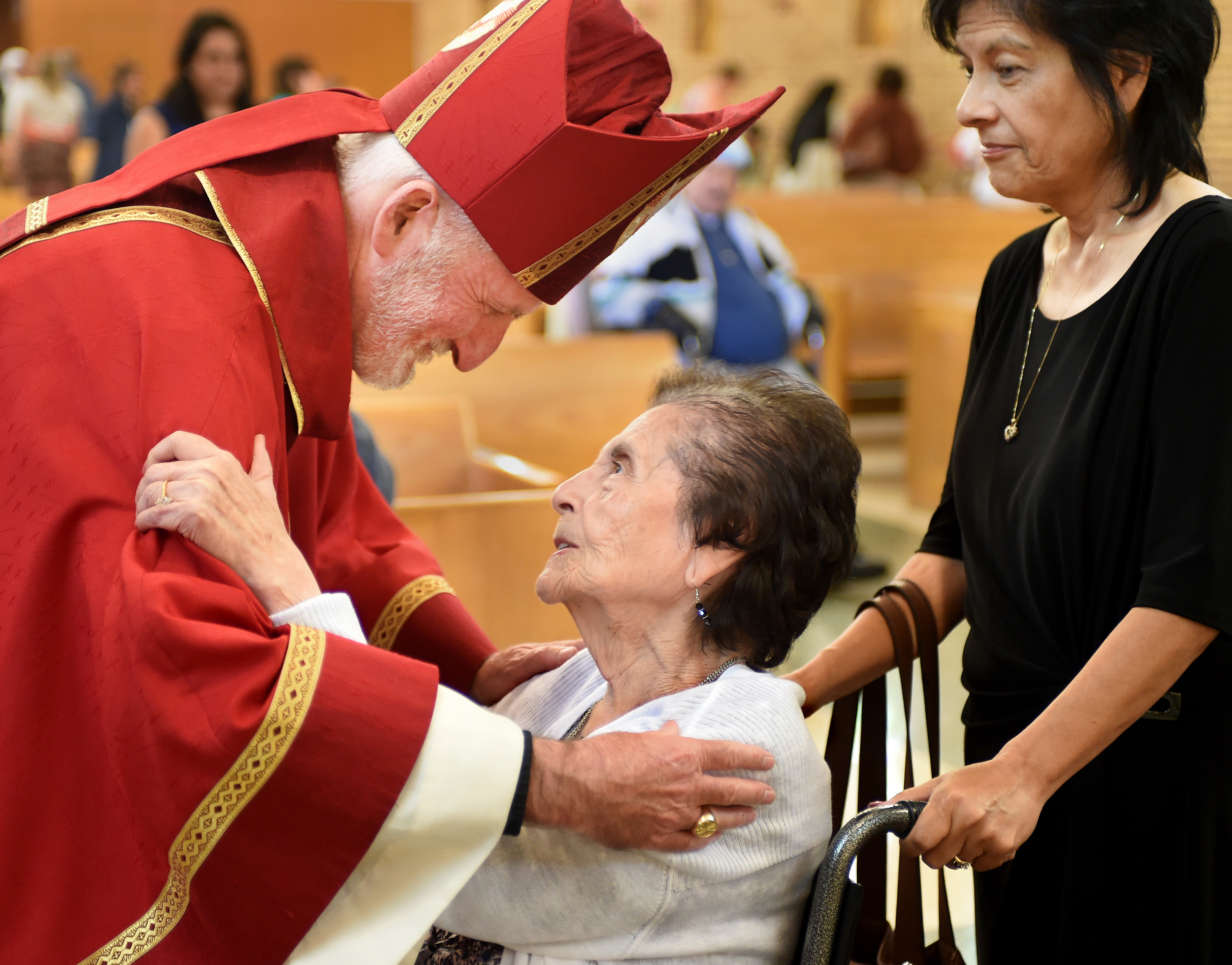 Bishop David G. O'Connell, Auxiliary Bishop of the San Gabriel Pastoral Region, Archdiocese of Los Angeles gives a warm embrace to Stella Lopez, 97, a resident at Santa Teresita. (Photo: Walt Mancini/Pasadena Star-News)
