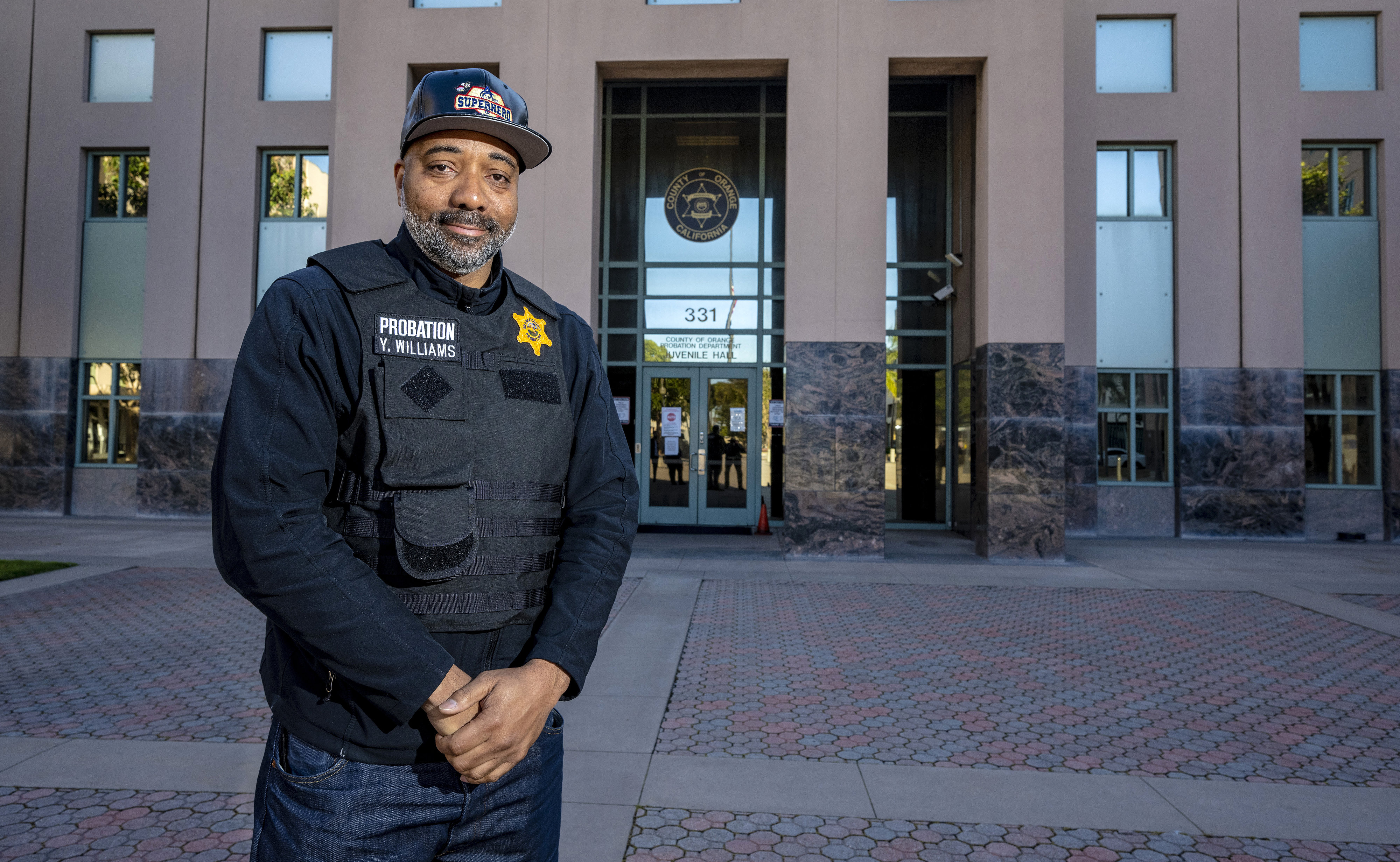Yuri Williams is a a deputy juvenile correctional officer for the Orange County Probation Department. Here, he stands outside Orange County Juvenile Hall in Orange on Friday, March 31, 2023. Williams dresses as up superheroes and visits sick children in hospitals. (Photo by Mark Rightmire, Orange County Register/SCNG)