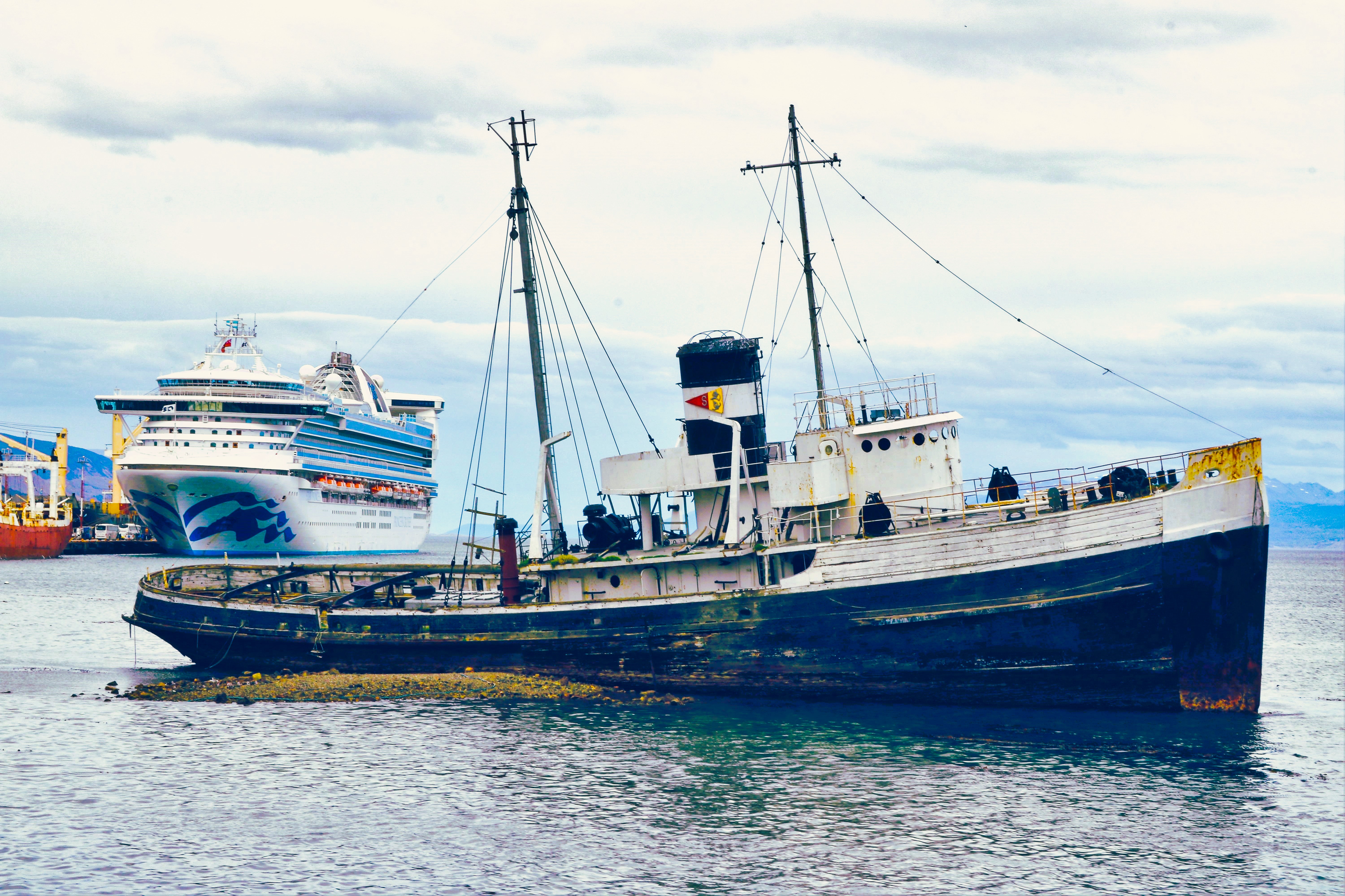Beached since 1957, the St. Christopher naval boat, in the foreground of a docked Star Princess, rests in the Beagle Channel off Ushuaia, Argentina. (Photo by David Dickstein)