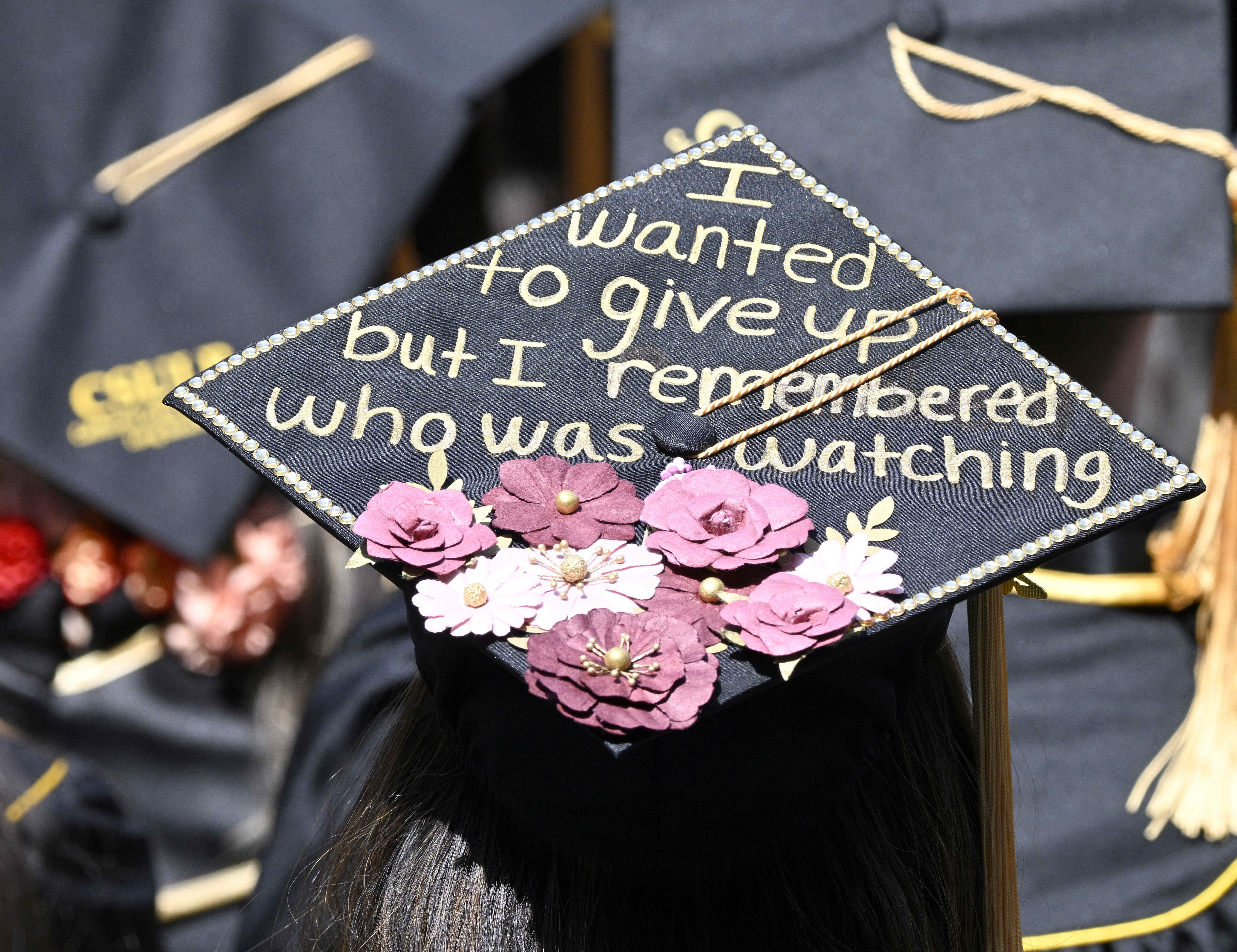 Many mortar boards were decorated in style for the College of Natural Sciences & Mathematics, graduation of California State University of Long Beach at Angel Stadium in Anaheim on Monday, May 15, 2023. (Photo by Brittany Murray, Press-Telegram/SCNG)