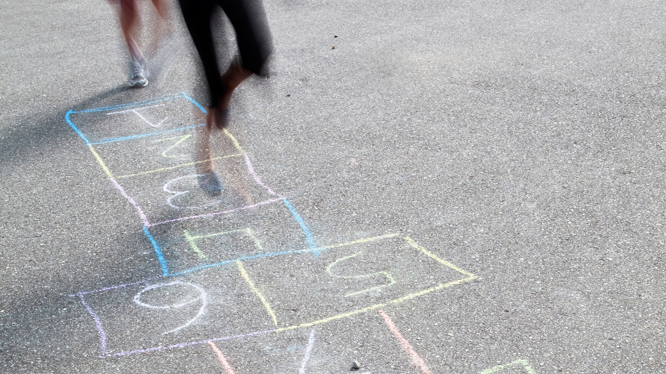 Girls play hopscotch during recess, and recite ADHD statistics