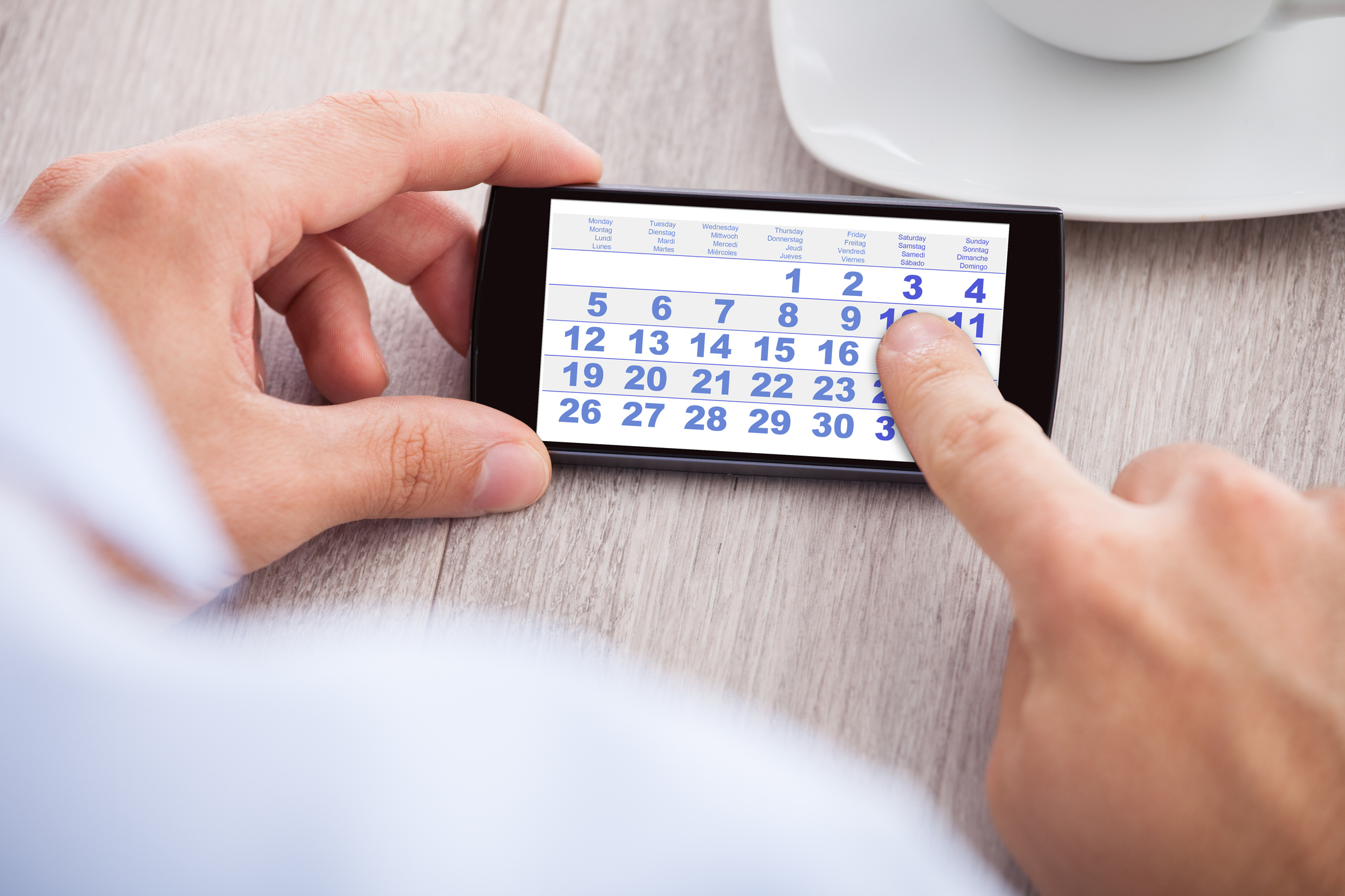 A man uses the digital calendar on his phone.