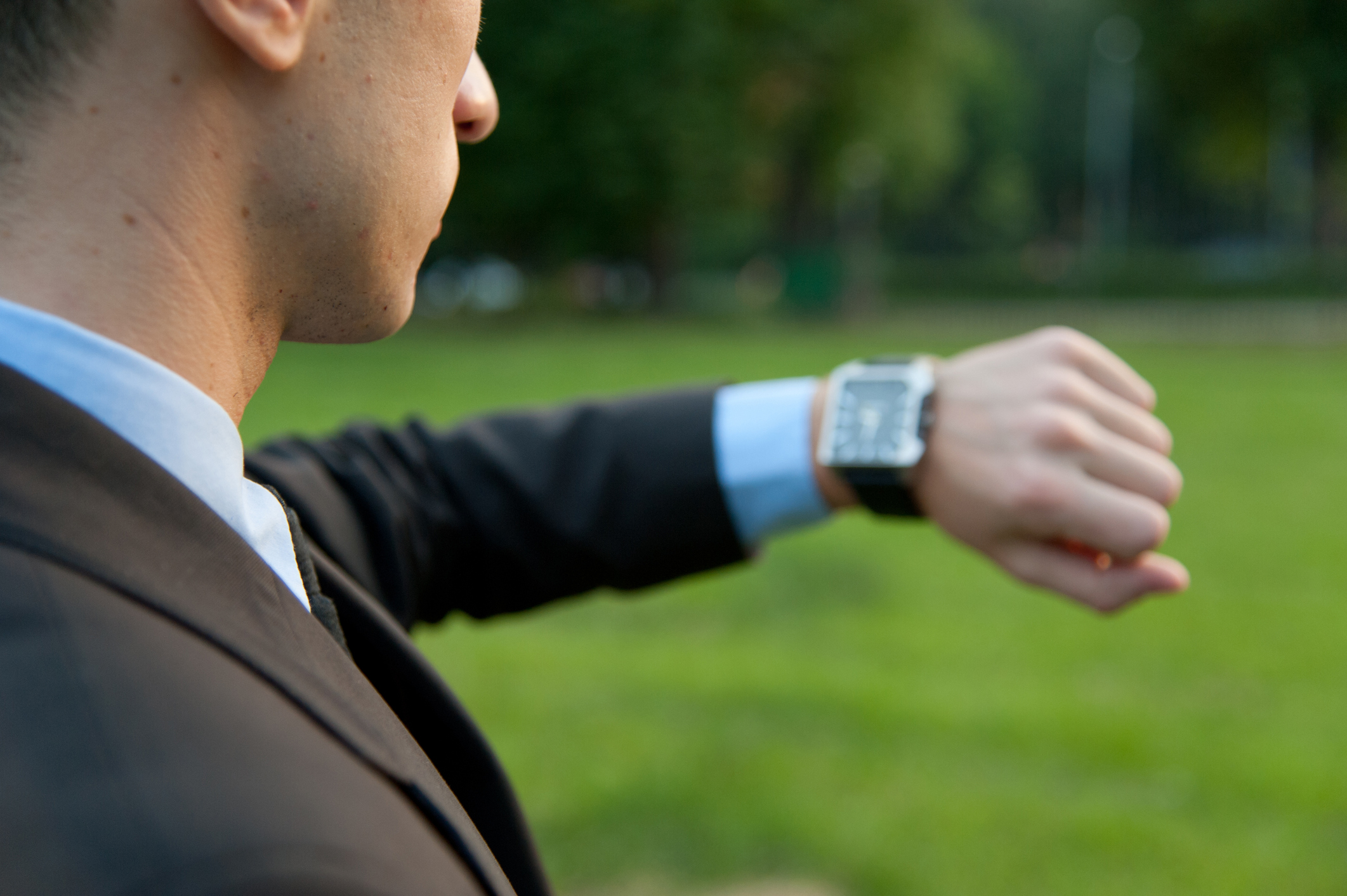 A man checks his watch, to remind himself of how to be on time