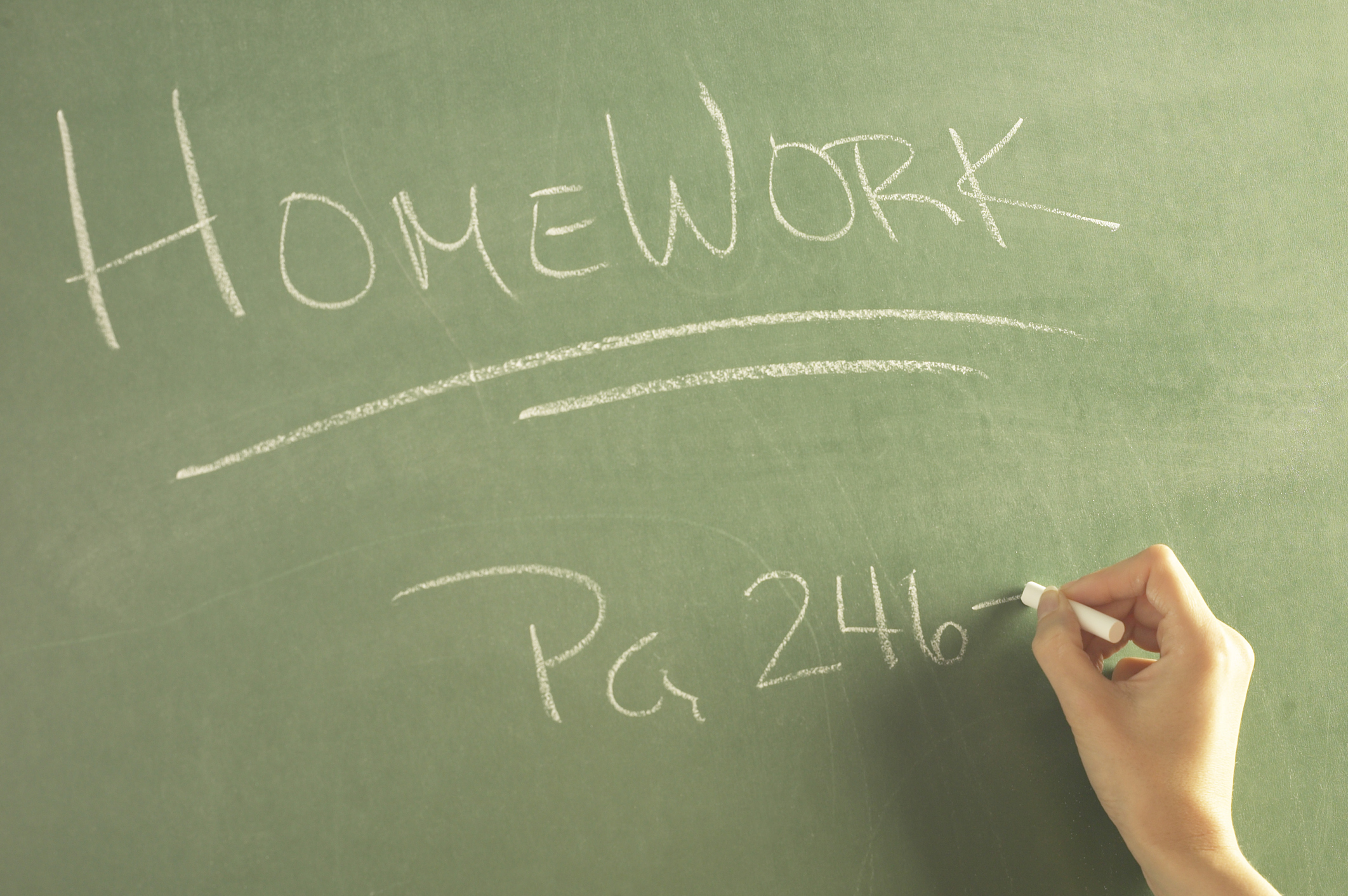 A teacher assigning homework on the blackboard, which 504 accomodations for adhd can help your child to complete by improving communication.
