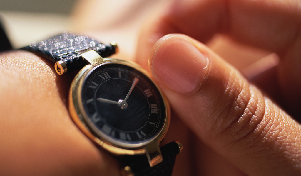 Close up of person with ADHD adjusting their wrist watch to better manage their time