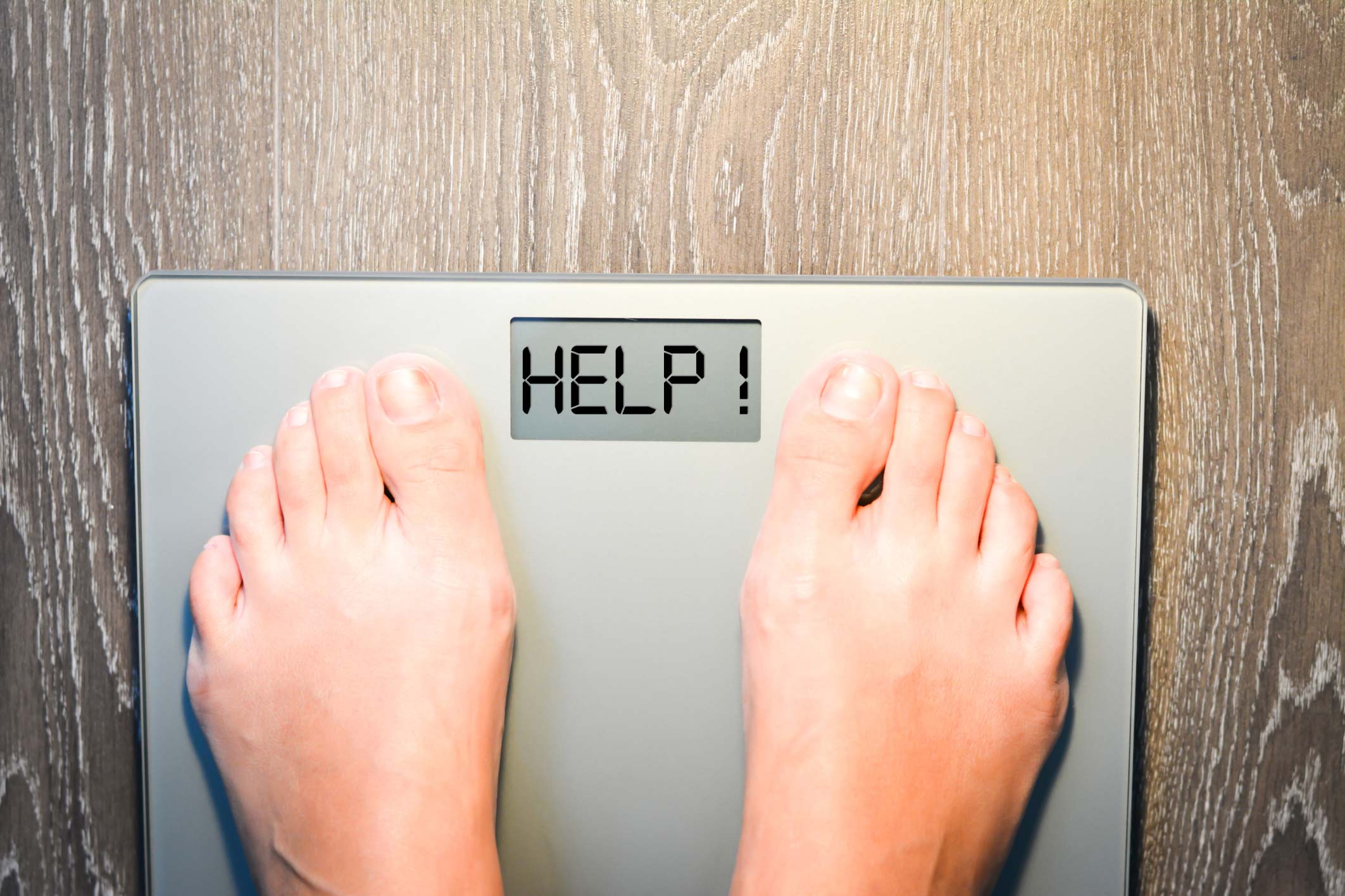 Someone with ADHD standing on a scale to track their weight loss