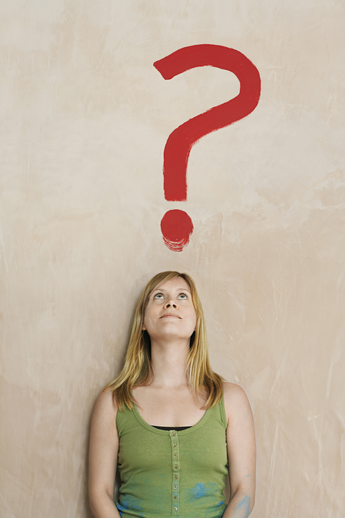 ADHD test. A woman in a green shirt stares up at an imaginary red question mark and wonders, 'Do I have adhd?' She takes the ADD test for adults.