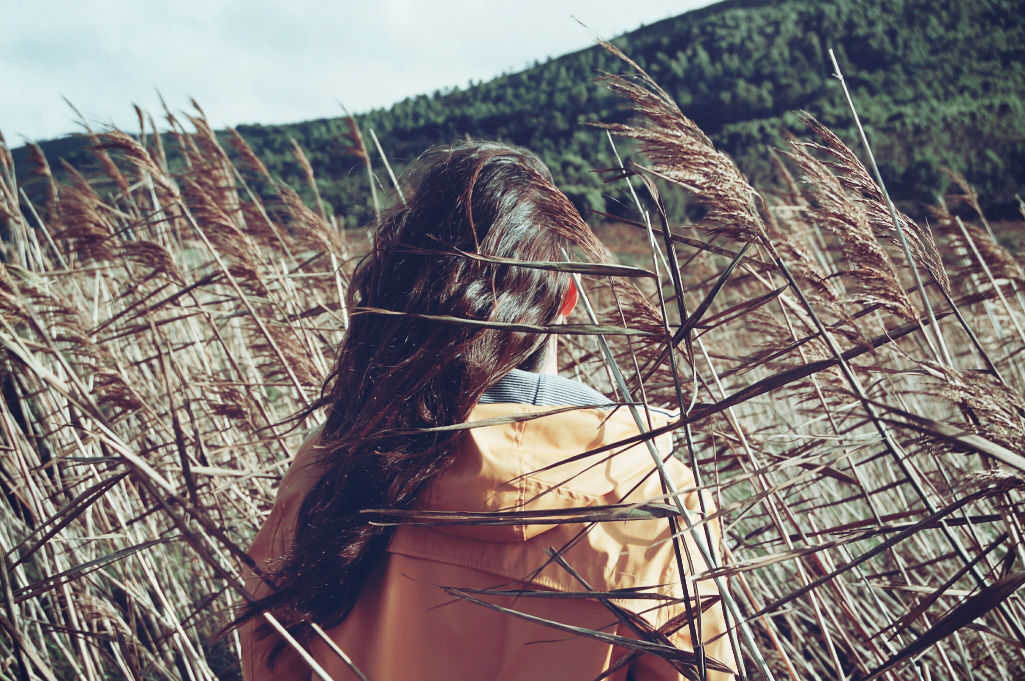 Teen girl with ADHD and eating disorder walking through windy field