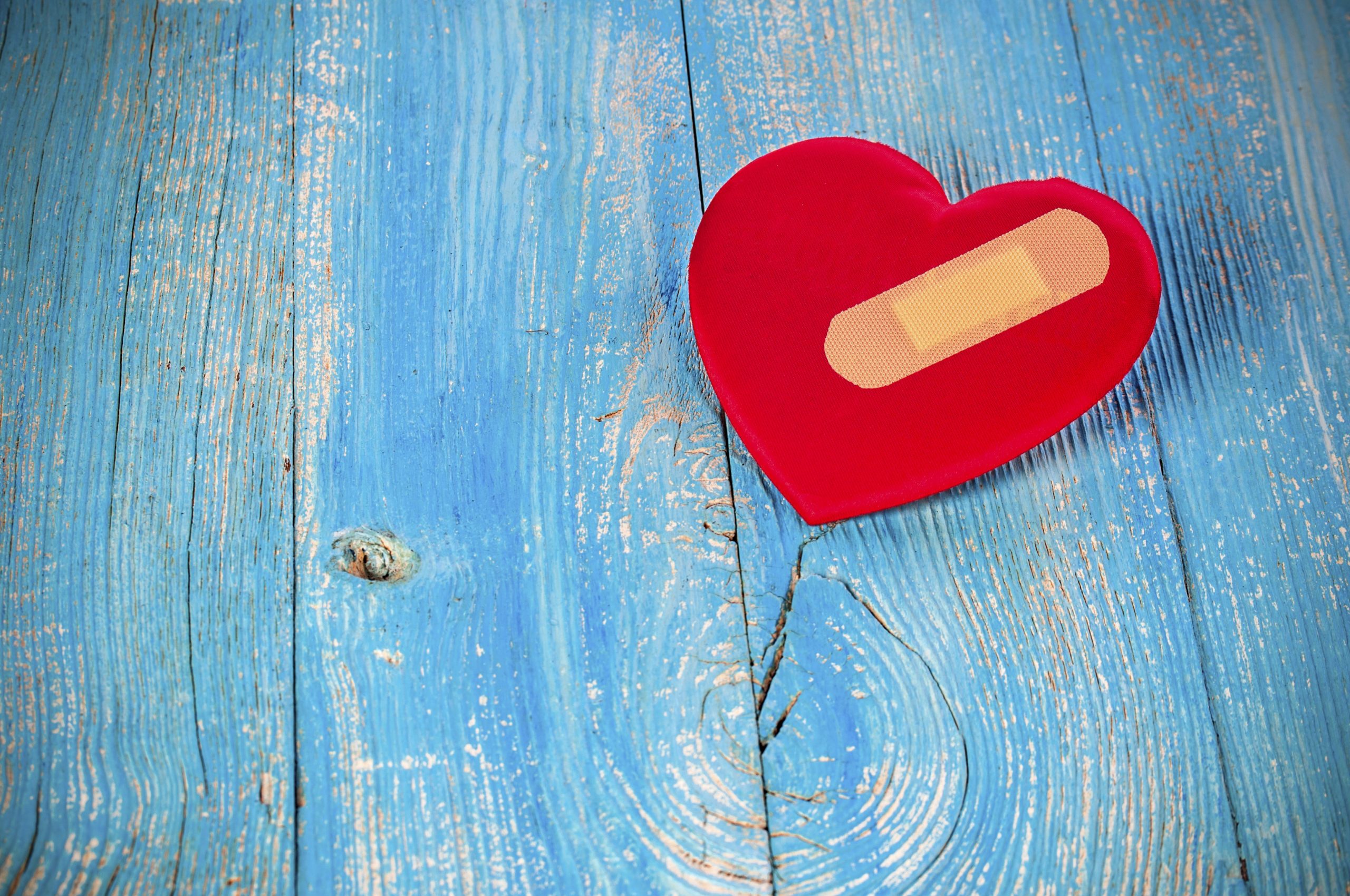 A red heart with a Band-Aid that represents the damage that hurtful comments can do to a child with ADHD