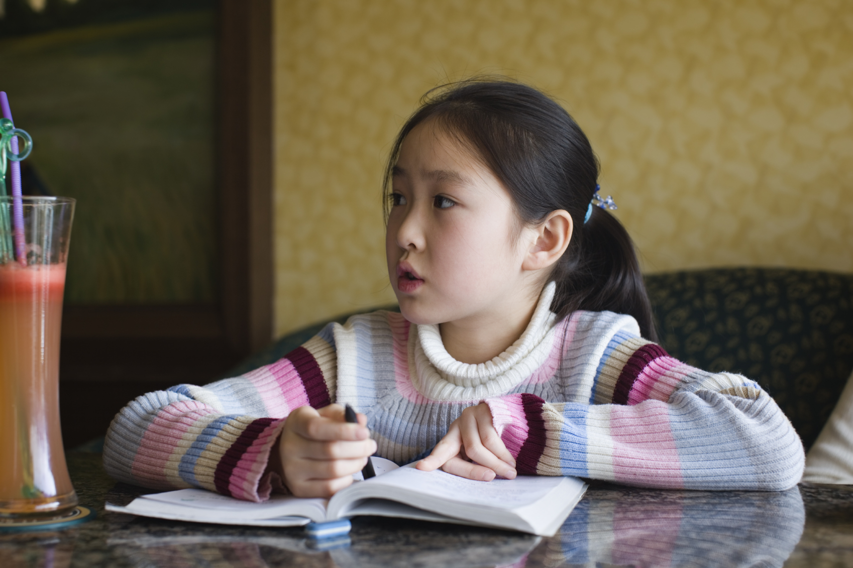 A young girl experiencing frustration during homework time