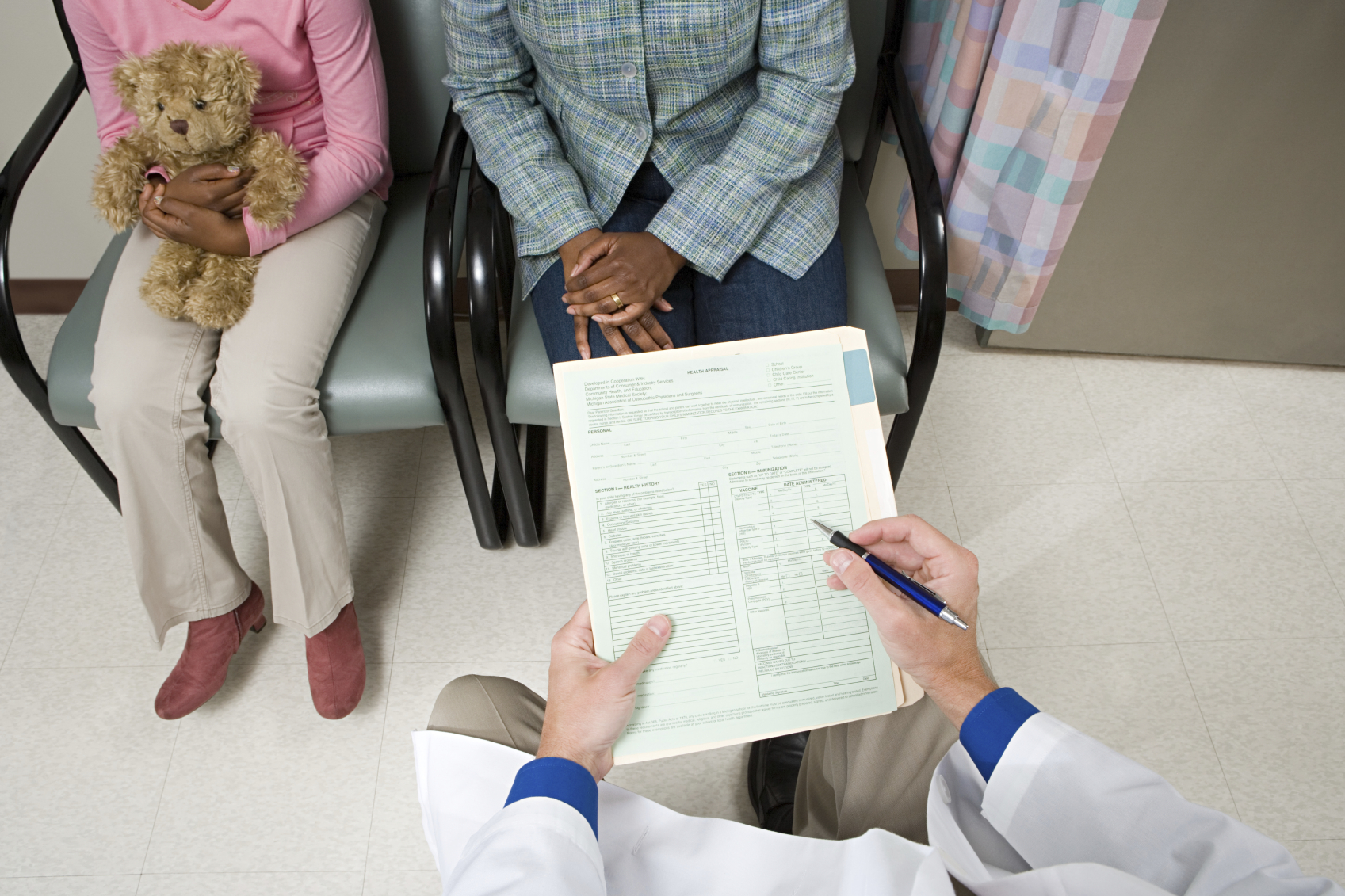 A doctor filling out a questionnaire for a patient