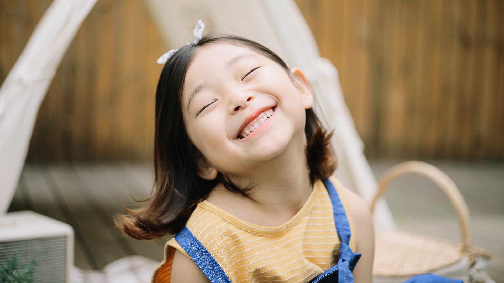 A girl with ADHD smiles because her parents use positive parenting techniques.