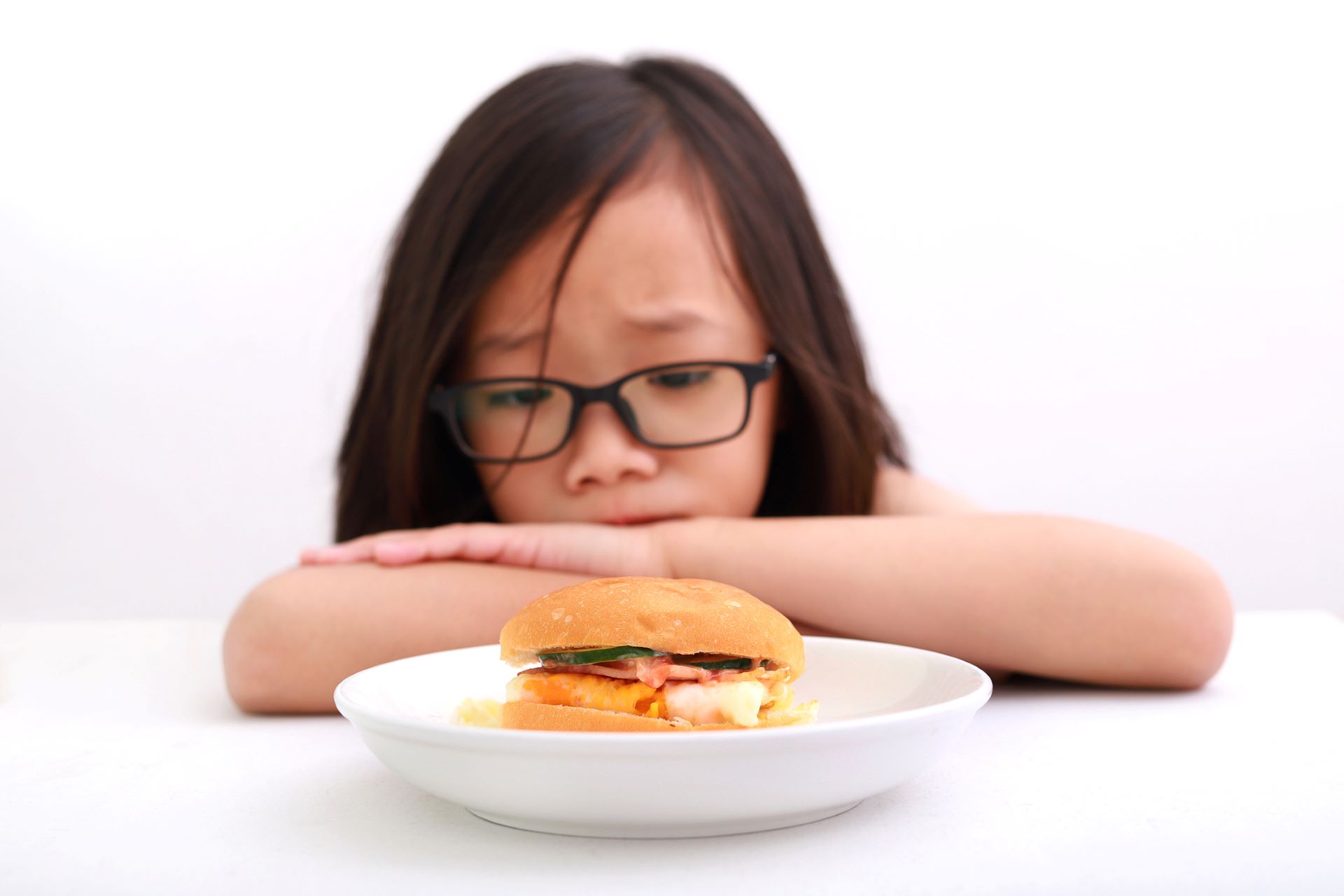 picky eating - child looking concerned over a dish