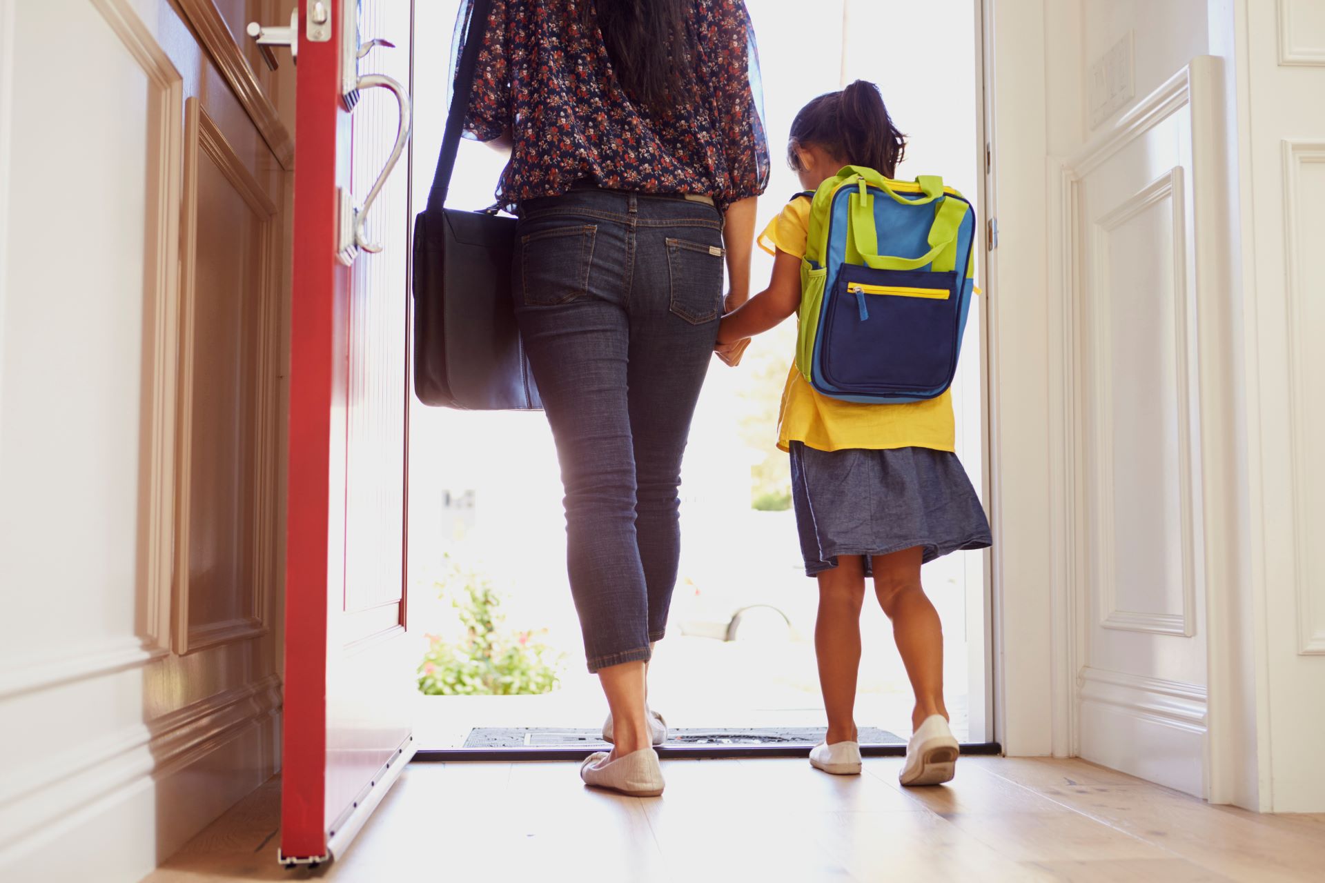 photo of mother and daughter walking out door.