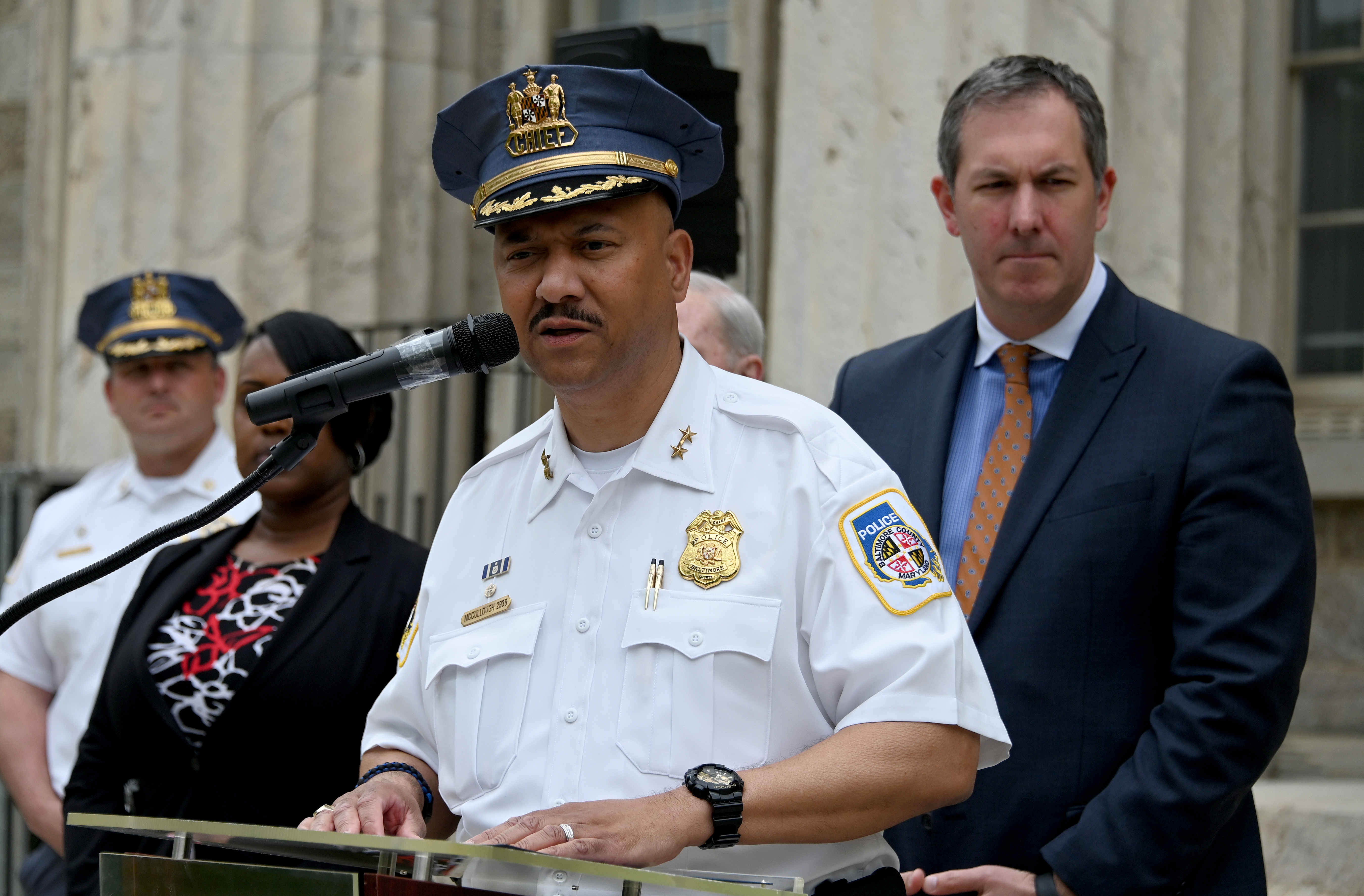 Baltimore County Police Chief Robert McCullough speaks about the arrest of Dazhon Darien, Pikesville High's athletic director, who allegedly used artificial intelligence to create a fake racist recording of the school's principal. On right is Baltimore County Executive John Olszewski, Jr. (Kim Hairston/Staff)