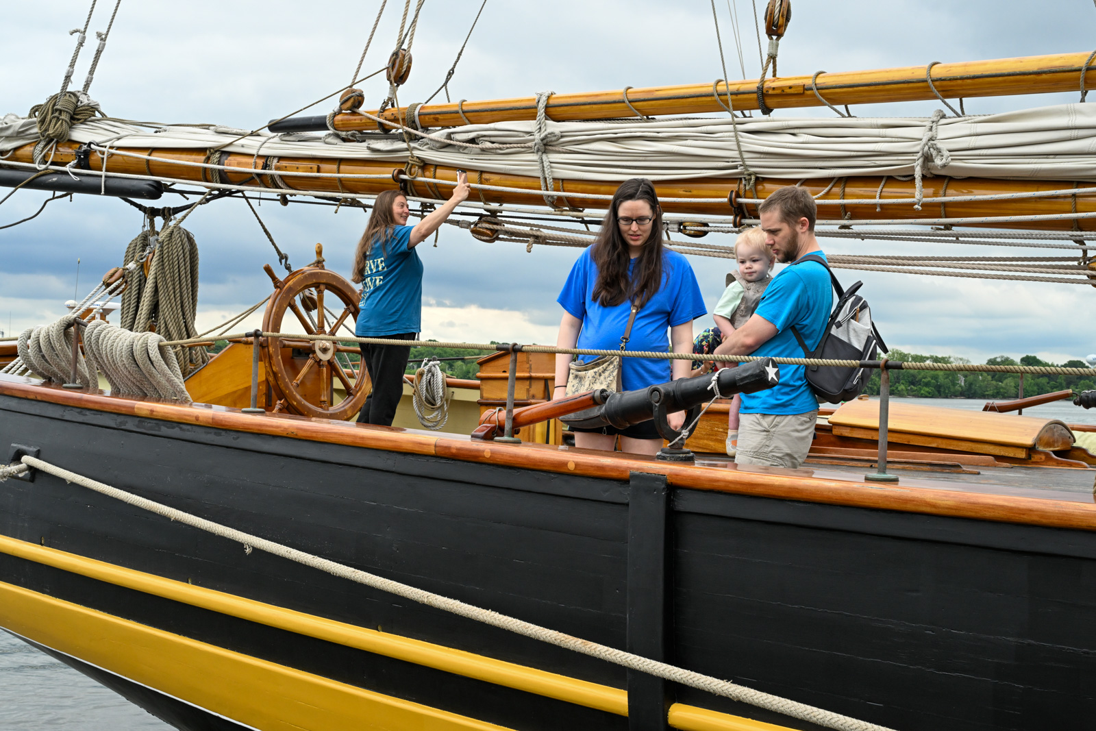 Melissa Thompson, of Edgewood, left, takes a selfie at the helm while Shannon Paulin, Greg Paulin and Wyatt Paulin, 2, look at one of the cannons on board the Pride of Baltimore ll during a free deck tour at Frank J. Hutchins Memorial Park dock in Havre de Grace. (Karen Jackson /Freelance)