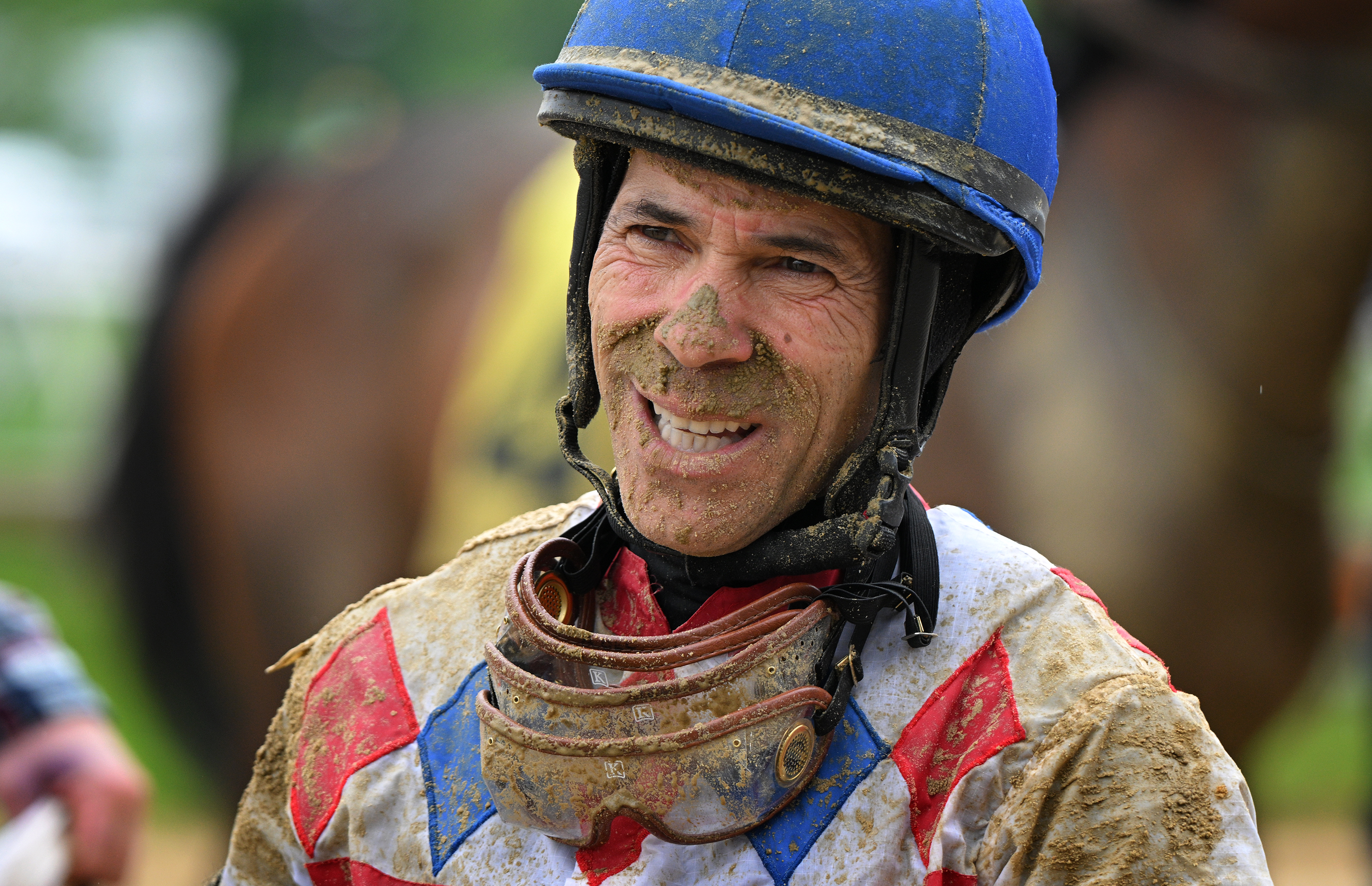 Jockey Alberto Delgado covered in mud after finishing third in the first race of the day while aboard Laddie Dance. The 2024 Preakness at Pimlico Race Course Saturday. (Lloyd Fox/Staff)