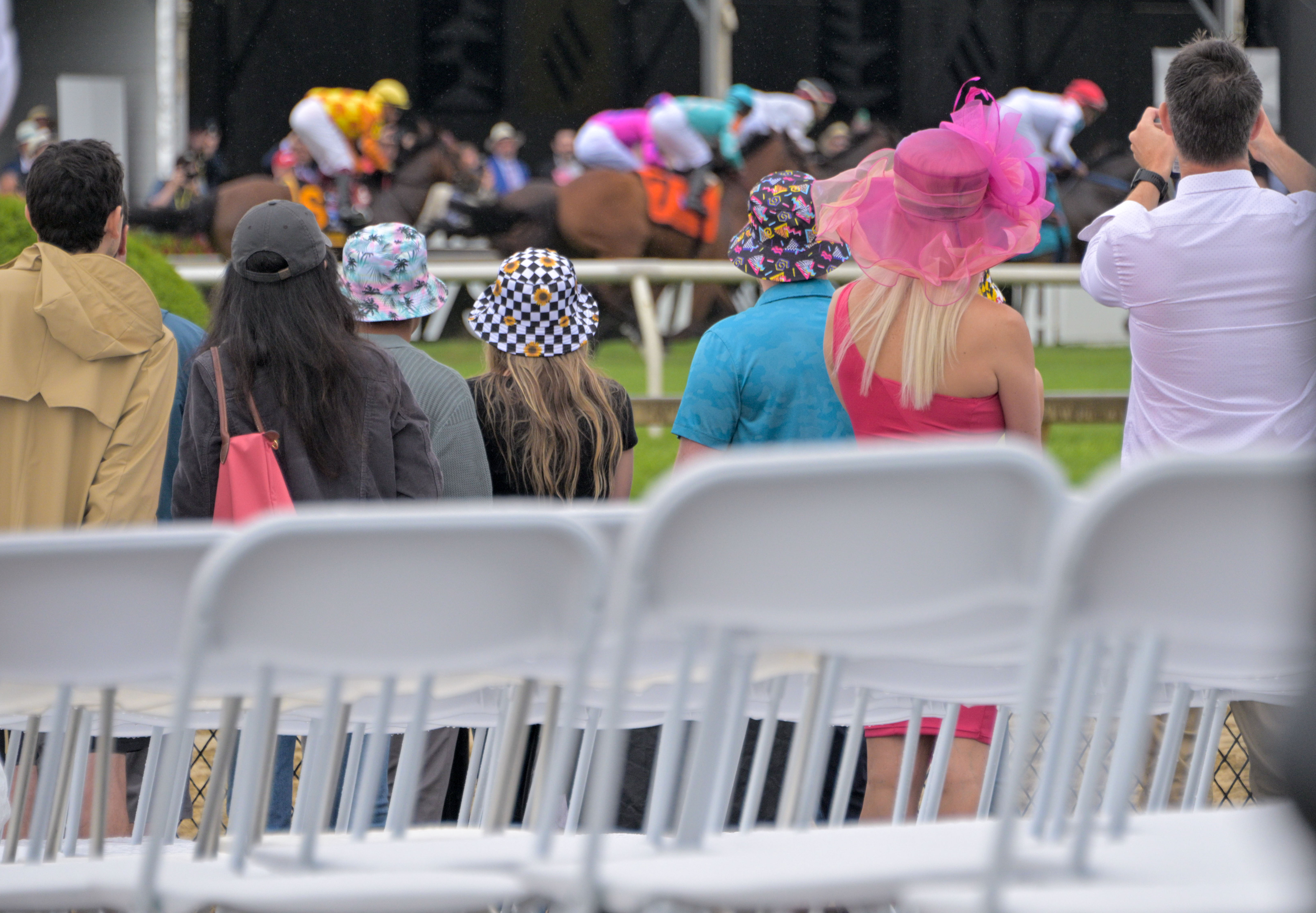 Many empty chairs rest unclaimed as spectators watch the start of the 73rd running of the Gallorette Stakes during Preakness day at Pimlico Race Course. (Karl Merton Ferron/Staff)