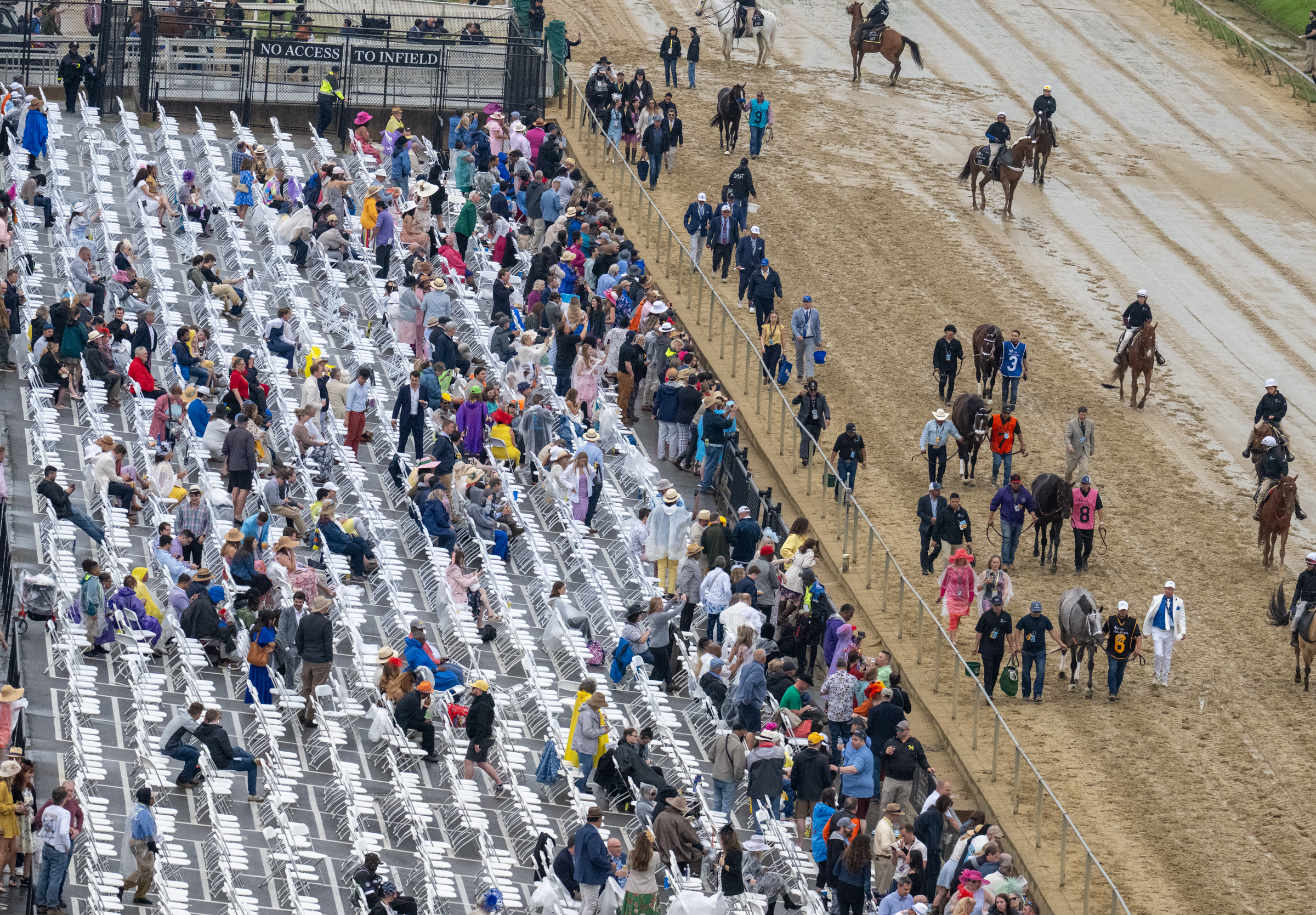 Preakness horses parade in front of a sparse crowd seated on the apron before the running of the 2024 Preakness Stakes at Pimlico Race Course on Saturday. (Jerry Jackson/Staff)