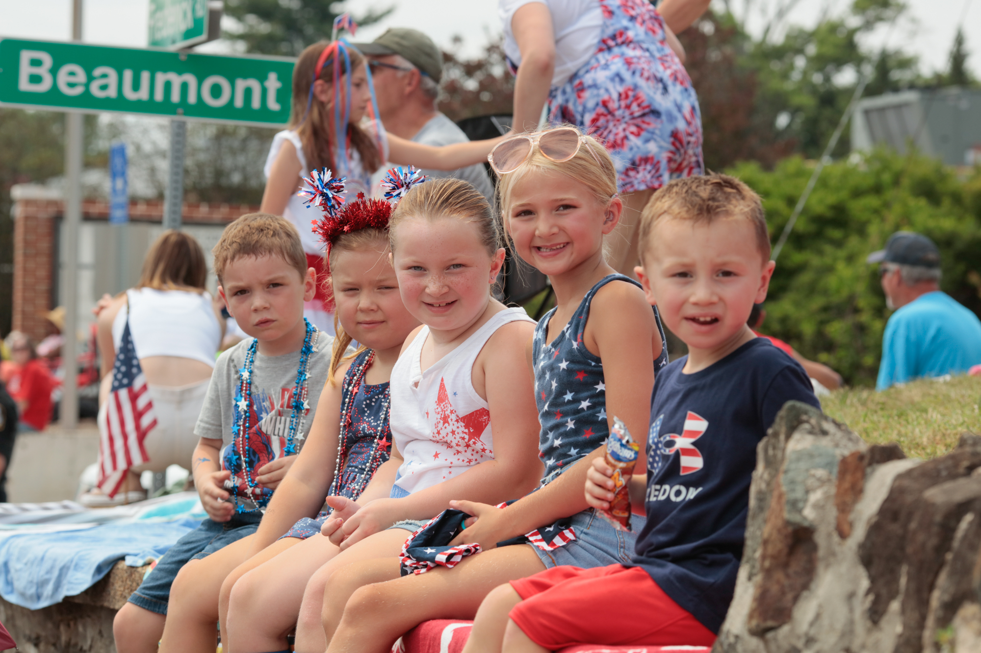 From left, Andy Murphy, 4, Ashton Murphy, 6, Harley Whiting, 7, Carly Williams, 7, Tucker Whiting, 3, sit on the stone wall to get a good view of the parade. The 78th annual Catonsville 4th of July parade along Frederick Road. (Nate Pesce/Freelance)