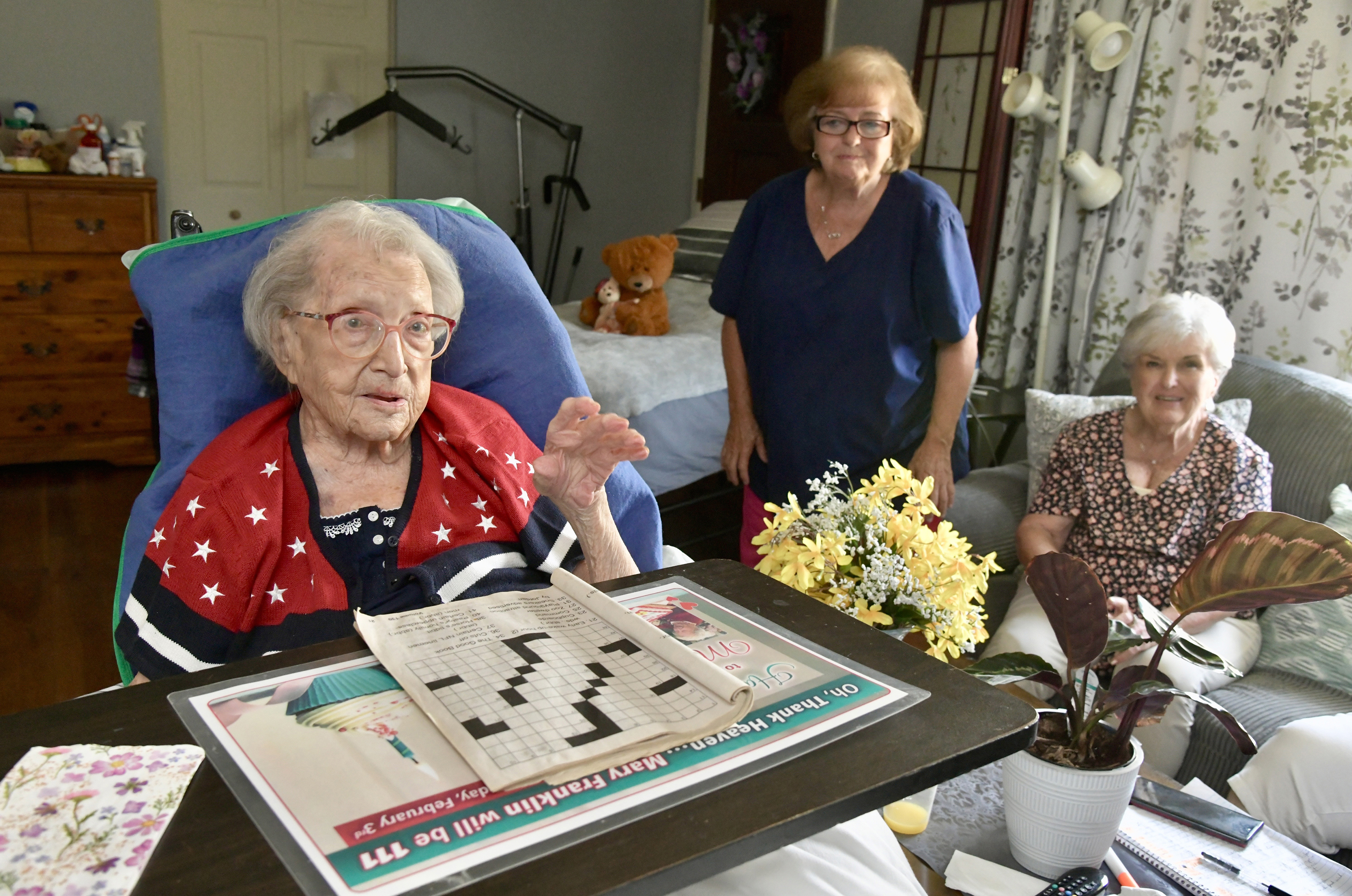 Mary Franklin, who turned 111 on Feb. 3, is now Maryland's oldest resident. The supercentenarian moved from an Eastern shore nursing home during Covid into the private home in Chestertown of Flo Campbell, right, whose sister, Bev Emore, center, is Franklin's primary caregiver. She enjoys crossword puzzles and Scrabble games, and the only medicine she takes is an occasional Tylenol.