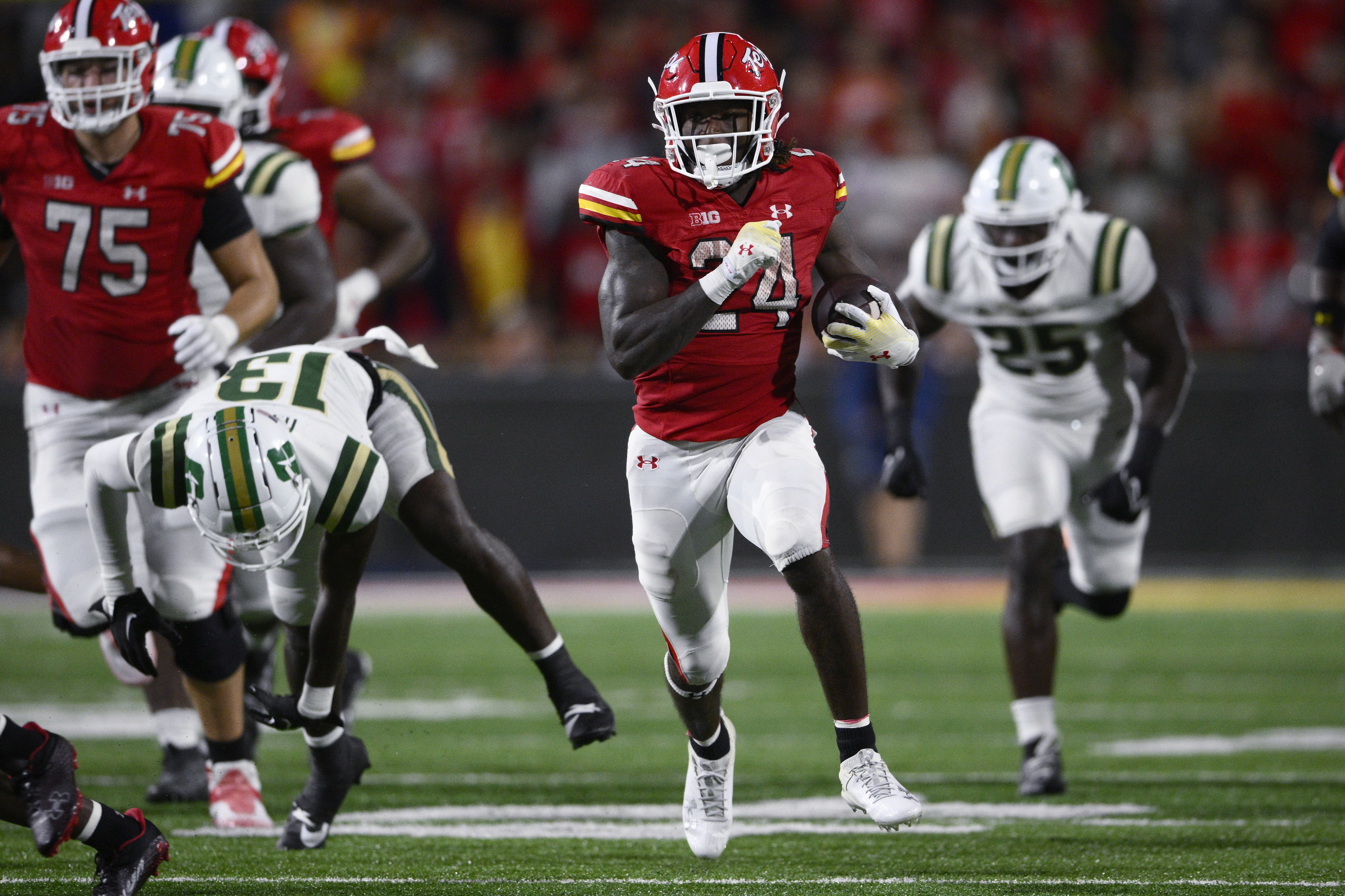 Maryland running back Roman Hemby (24) carries the ball past Charlotte defensive back Isaiah Hazel (13) during the second half of an NCAA college football game Saturday, Sept. 9, 2023, in College Park, Md. (AP Photo/Nick Wass)