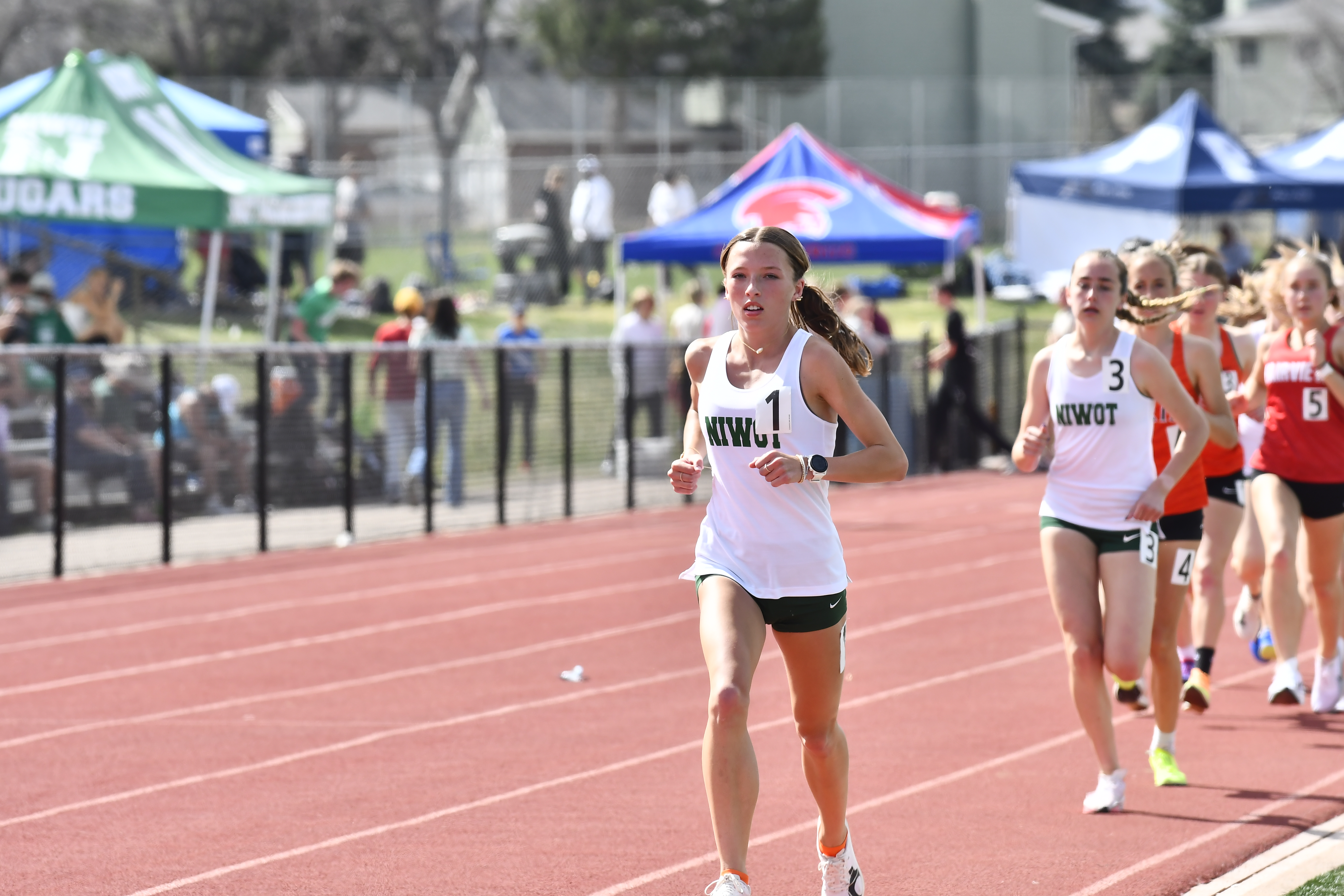 Niwot's Addison Ritzenhein leads the pack at the start of the 3,200-meter run during the Boulder County track championships at Spangenberg Field on April 13, 2024. (Alissa Noe/BoCoPreps.com)