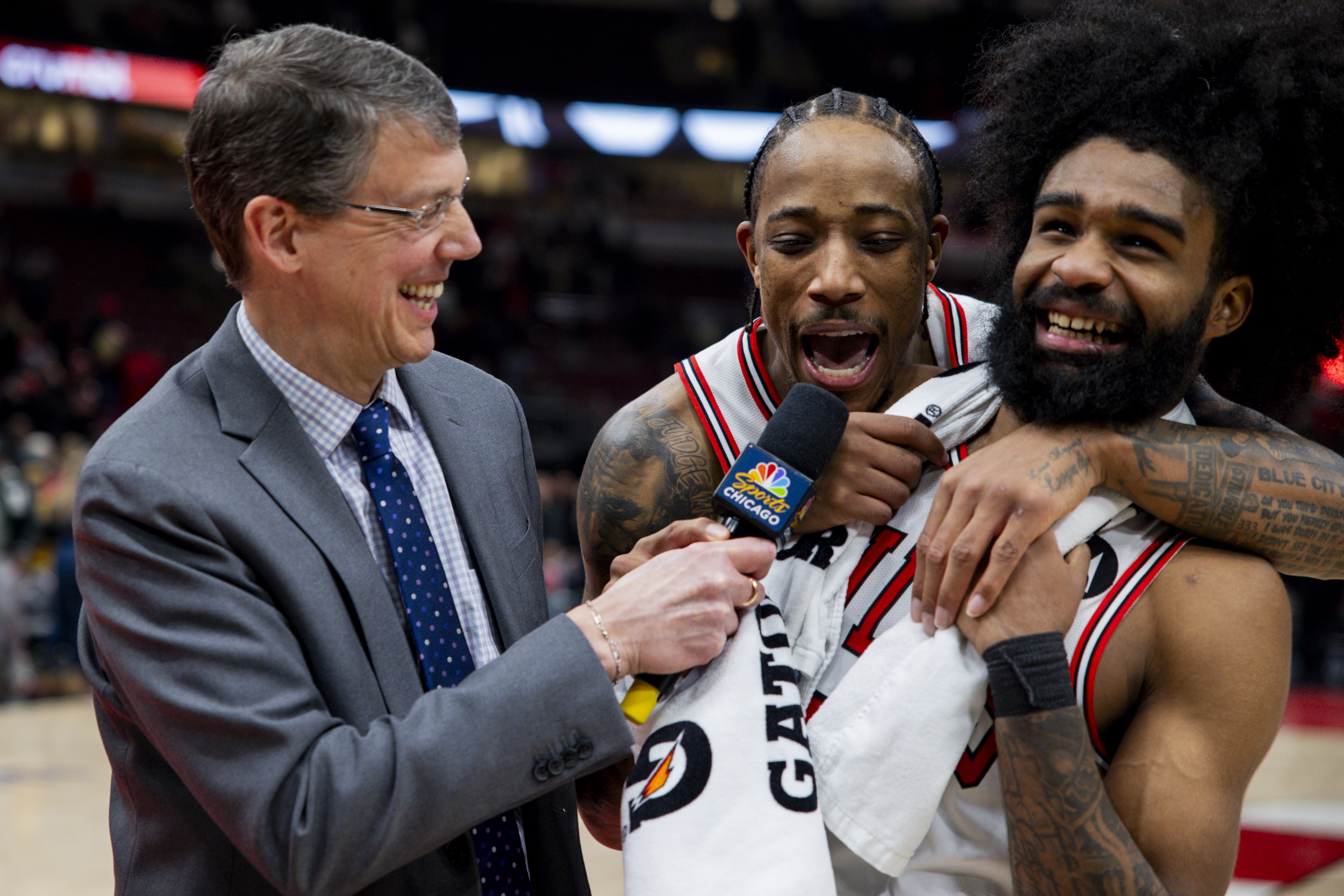 Bulls forward DeMar DeRozan, center, interrupts a postgame interview with guard Coby White on Feb. 6, 2024, at the United Center. (Vincent Alban/Chicago Tribune)