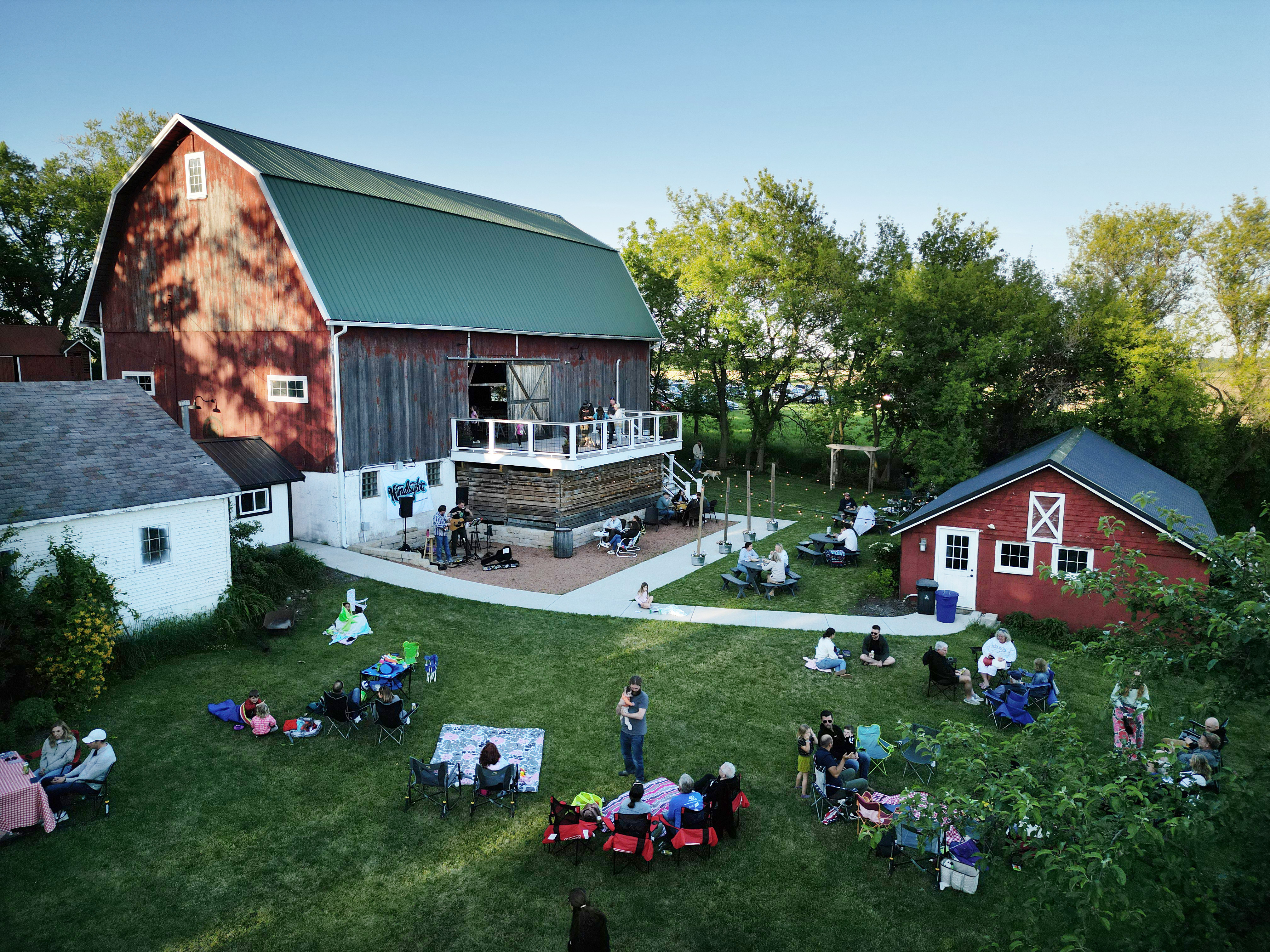 People gather out on the grass at Mapleton Barn during their Pizza Farm event on May 30, 2024, in Oconomowoc, Wisconsin. (Stacey Wescott/Chicago Tribune)