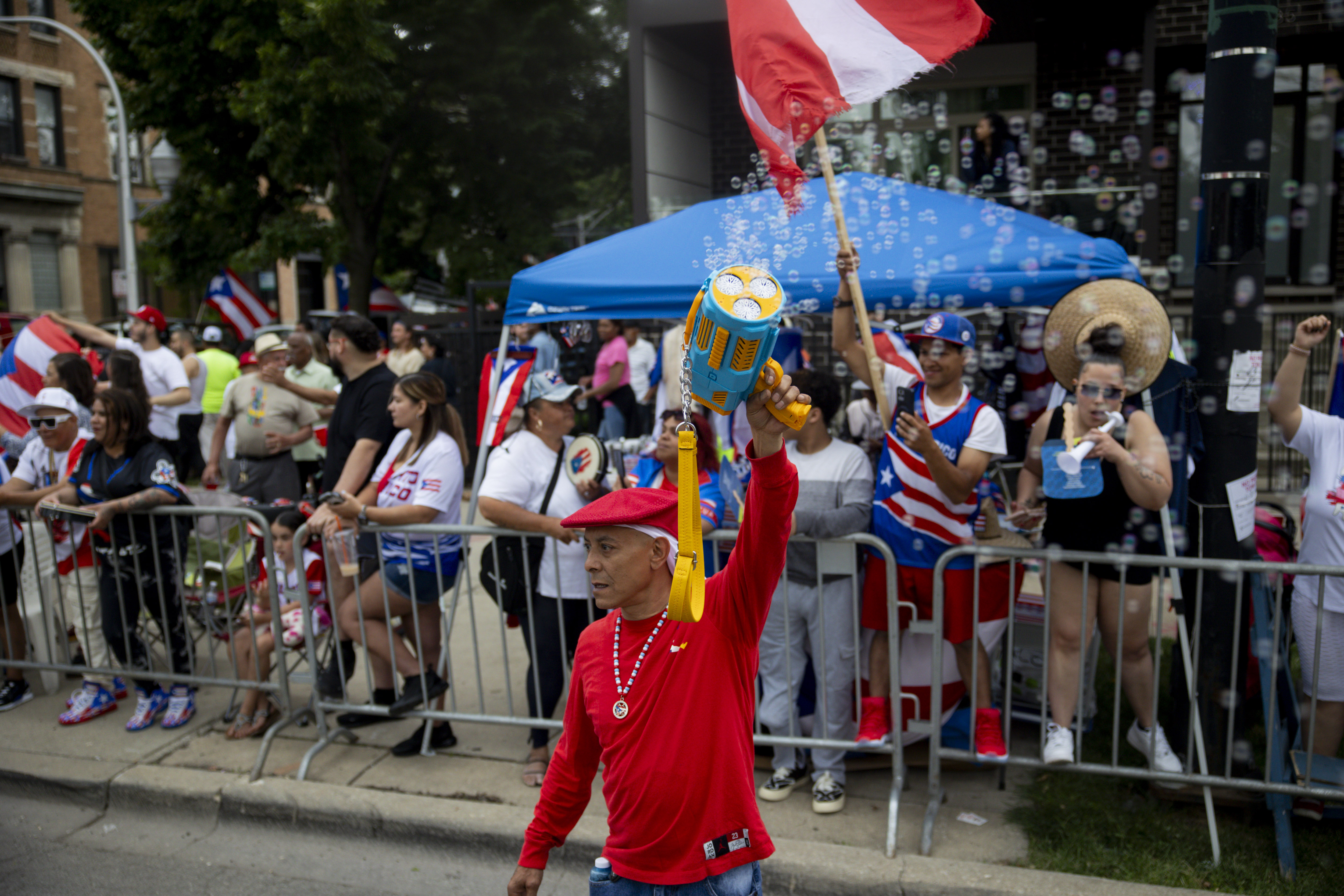 Davy Vasquez, a parade participant, waves a bubble wand during the 46th Puerto Rican People's Day Parade on on June 8, 2024, in Humboldt Park in Chicago. (Vincent Alban/Chicago Tribune)