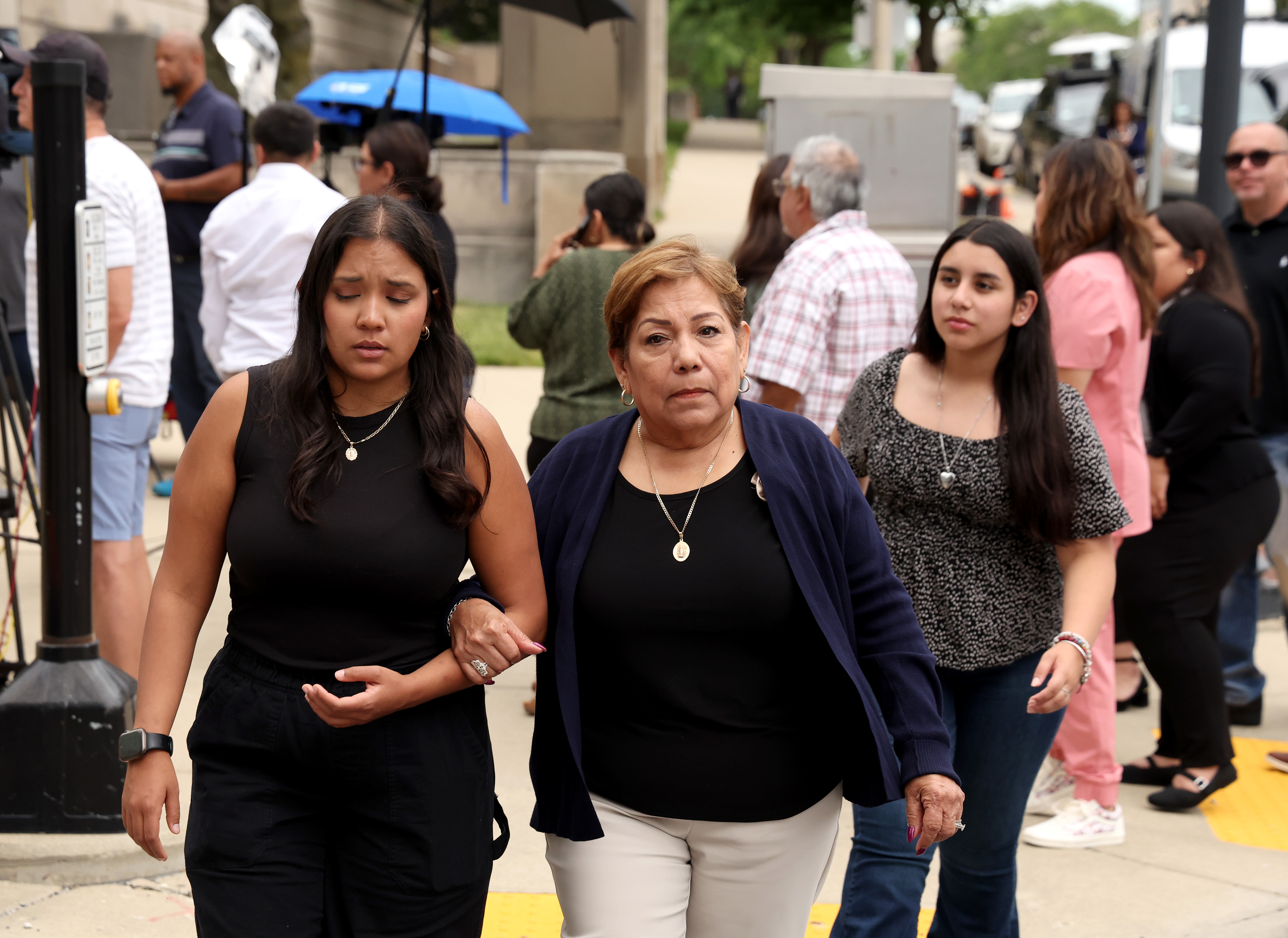 Maria Uvaldo, center, wife of Highland Park shooting victim Edward Uvaldo, center, heads home with Noni Guzman, left, and Samantha Mendez, following Wednesday's hearing, June 26, 2024, at the Lake County Courthouse in Waukegan. (Stacey Wescott/Chicago Tribune)