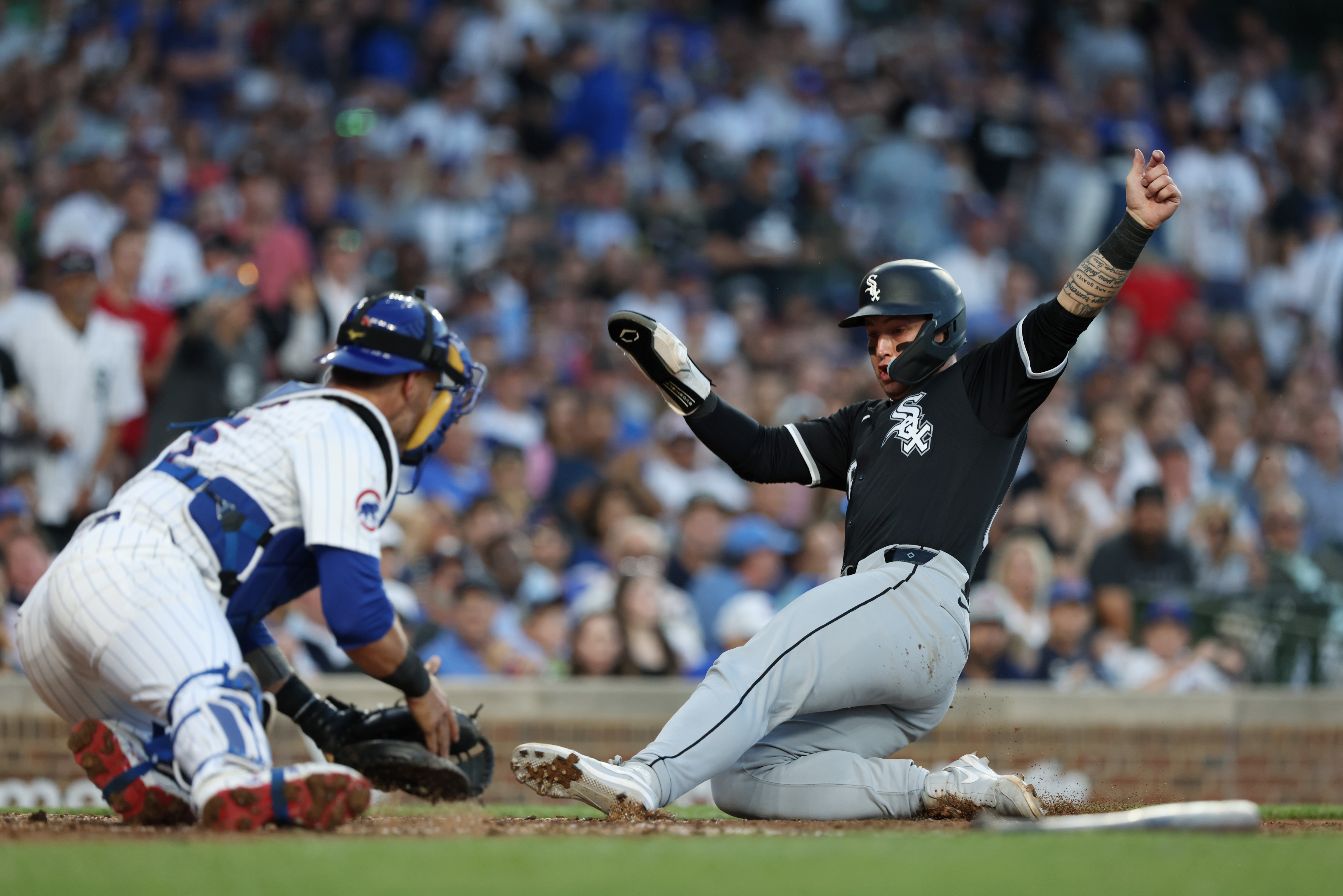 White Sox catcher Korey Lee, right, slides to score as he beats the tag from Cubs catcher Yan Gomes in the fourth inning at Wrigley Field on June 5, 2024, in Chicago. (John J. Kim/Chicago Tribune)