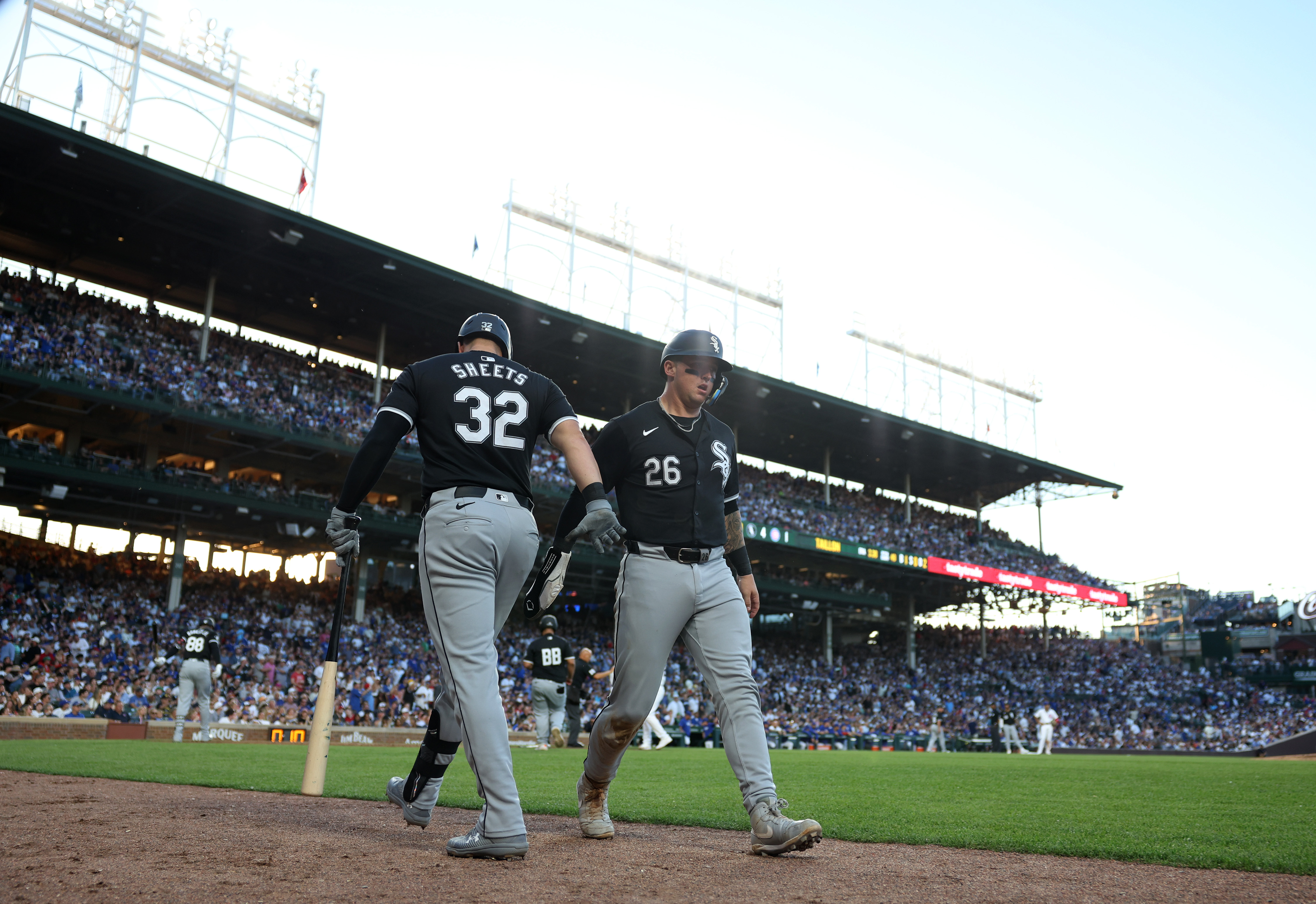 White Sox catcher Korey Lee (26) is congratulated by first baseman Gavin Sheets (32) after scoring in the fourth inning against the Cubs at Wrigley Field on June 5, 2024, in Chicago. (John J. Kim/Chicago Tribune)
