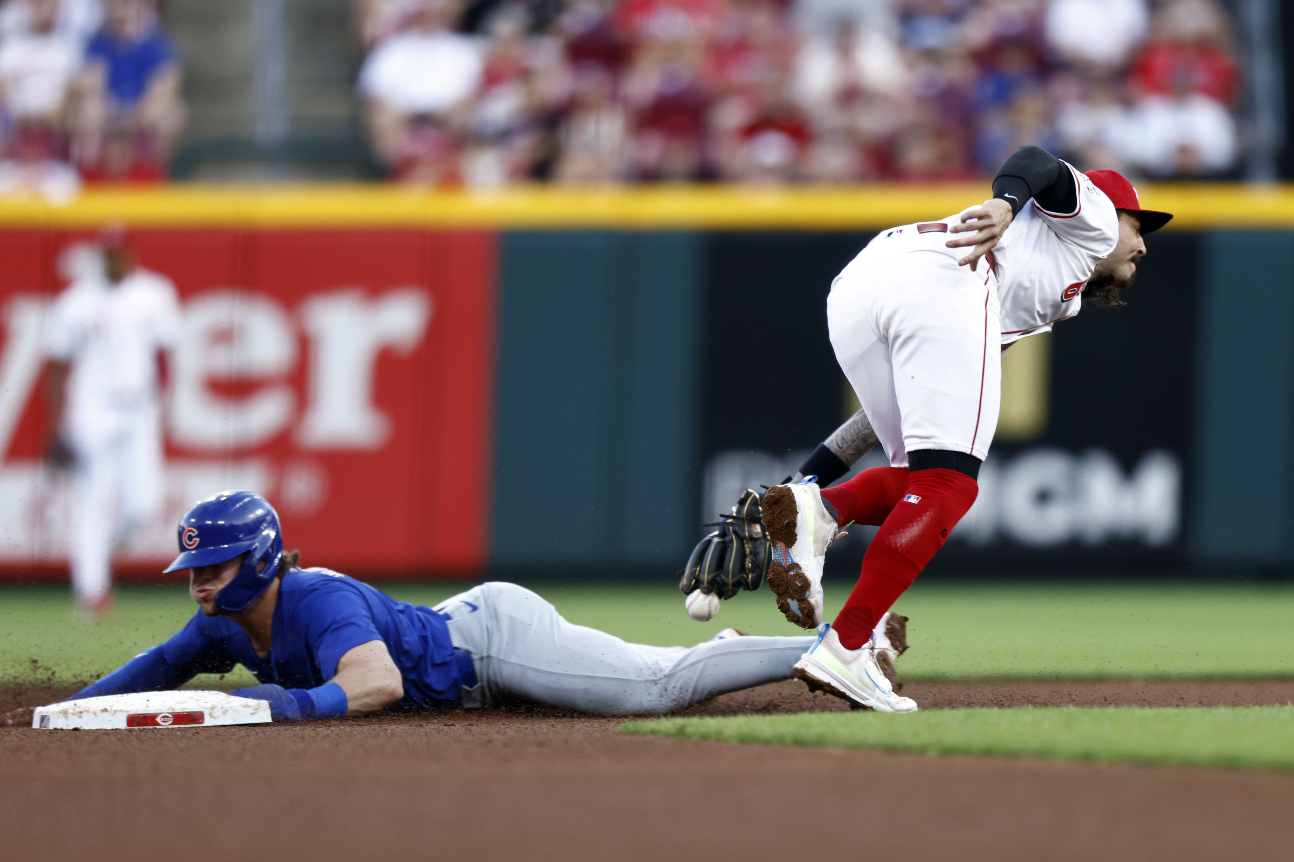 Reds second baseman Jonathan India can't catch the throw as the Cubs' Nico Hoerner steals second on June 6, 2024, in Cincinnati. (AP Photo/Paul Vernon)